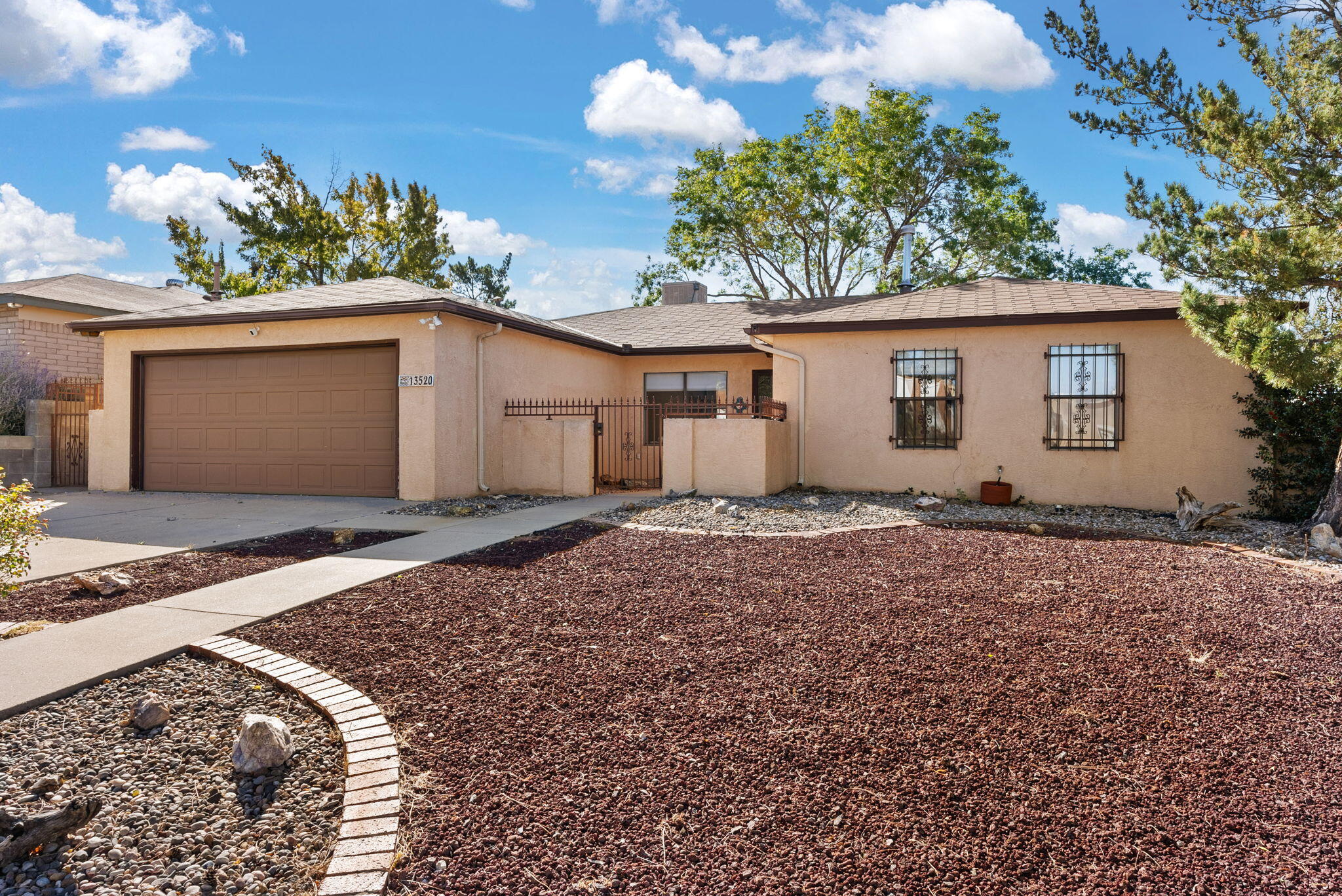 Welcome to this charming 3 bedroom, 1 & 3/4 bath home in the Embudo Canyon Neighborhood.  This home is complete with 2 living areas, one with a fireplace, a dining room and an eat in kitchen.  Enjoy the outdoors on your backyard open patio.  Listen to the tranquil sounds of the water feature which is part of the koi pond.  Beautiful views of the city and mountains.  Close to trails, shopping and the I-40.  Come see this lovely home today!