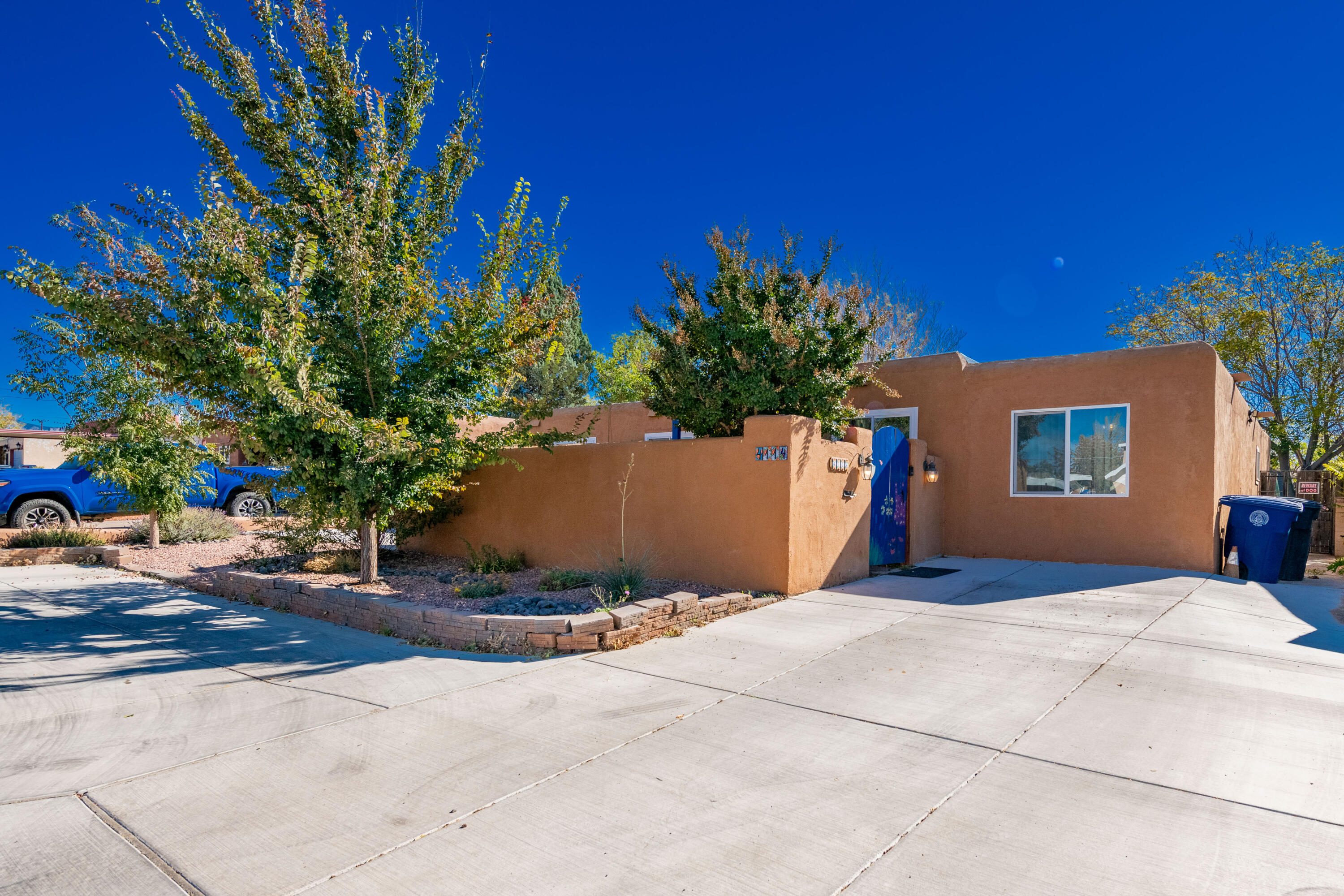 Welcome to this charming three-bedroom, two-bathroom home in the heart of Albuquerque! Enjoy the spacious layout with three living areas and a cozy fireplace. The remodeled kitchen, newer granite countertops, and modern tile flooring, add comfort and style.  Brand new Master Cool A/C, newer windows and doors Outdoors, relax in the large backyard featuring a covered patio, large storage shed, grassy area, garden, and chicken coop for fresh eggs. Cherry, plum, peach and pomegranate fruit trees! The welcoming courtyard and ample parking add convenience, and the home is wheelchair accessible throughout. Don't miss this delightful oasis!