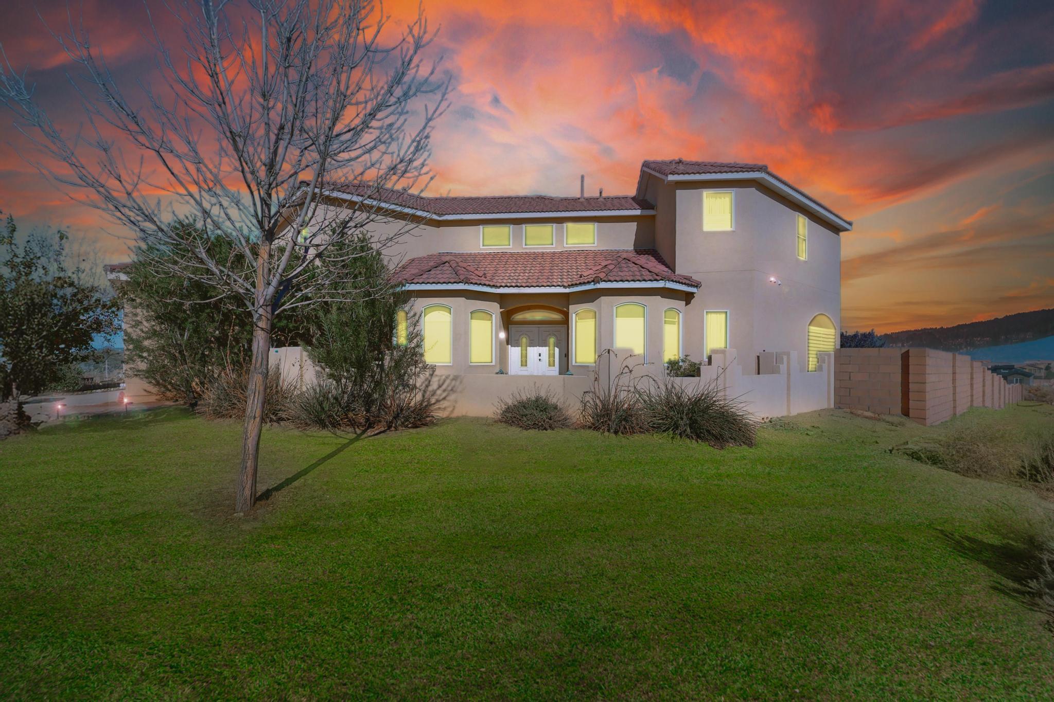 Enjoy breathtaking mountain views from this custom home on a large 1/2 acre lot. Delight in the Chef's Kitchen with granite countertops, beautiful brick tile backsplash, & custom cabinetry with stainless steel appliances.  The lovely kitchen opens into your beautiful living space with a gas fireplace and French doors that open onto your expansive wrap-around covered patio overlooking the Sandias. The backyard is waiting for you to make it your oasis with plenty of space for everything imaginable. Cozy dining room & separate kitchen nook are great for entertaining. Upstairs you'll find an amazing Loft/Game Room with more Stunning views!! The Primary Bedroom plus two additional bedrooms upstairs complete this home! 2 Sheds, NEW backyard block wall & Refrigerated Air!! (All Grass is Virtual)