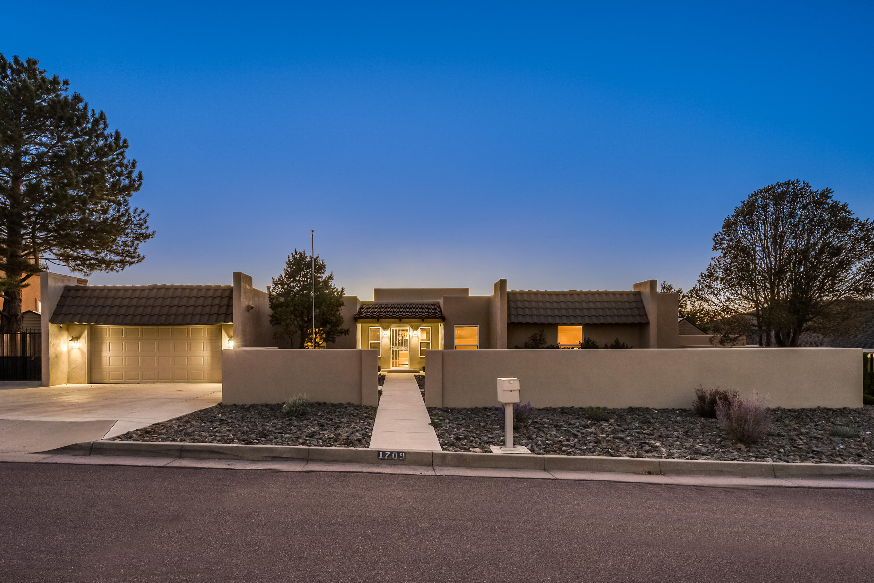 Welcome to this stunning one-story home built by Miller homes in the desirable Four Hills neighborhood! When entering the home, you are greeted with natural light throughout, 5 bedrooms, 3 bathrooms, two spacious living rooms, one of which has a beautiful hand-crafted stone fireplace to enjoy to cooler evenings. Large kitchen, complete with a butler pantry, offering ample space for culinary creations. Step outside to your expansive private backyard, where you can enjoy breathtaking city views and the tranquility of outdoor living. Offering assumable VA loan at an incredibly low 2.5%, a nearly new solar system that will be paid off at closing, this home is not only beautiful but also energy efficient. Enjoy walking trails, FH golf course, shops, easy access to Sandia Lab, KAF