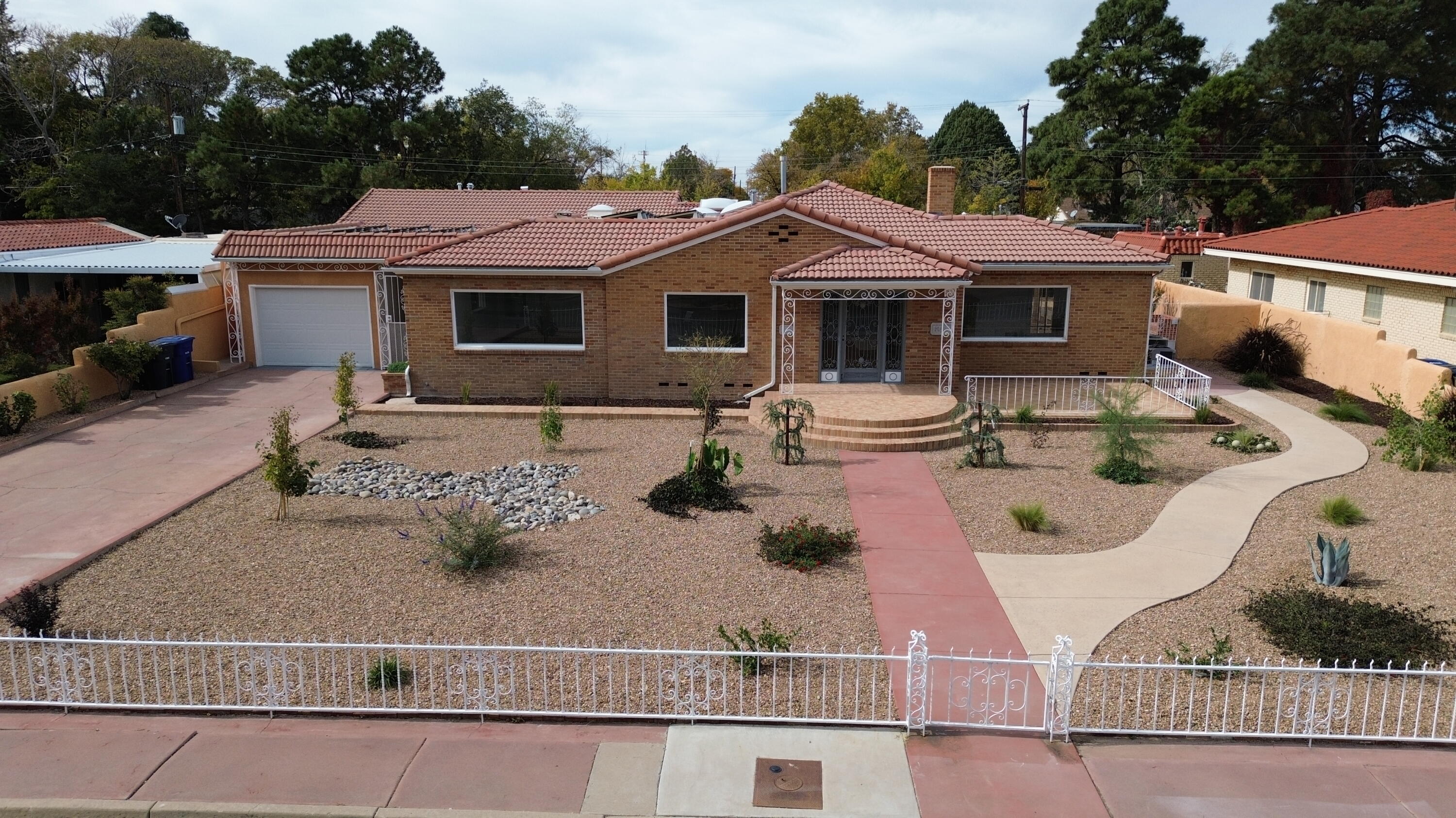 Welcome to this charming and spacious home in the heart of Albuquerque, minutes from UNM & Nob Hill.  This well-maintained residence offers a blend of comfort and style, perfect for those seeking a relaxed lifestyle.  Step inside to find an inviting living area with plenty of natural light, completely remodeled throughout, with new appliances.  Owned solar panels.  Electric bill less than $10 per month for over 5000 sqft of home.  Come see today! Owner Financing is available.