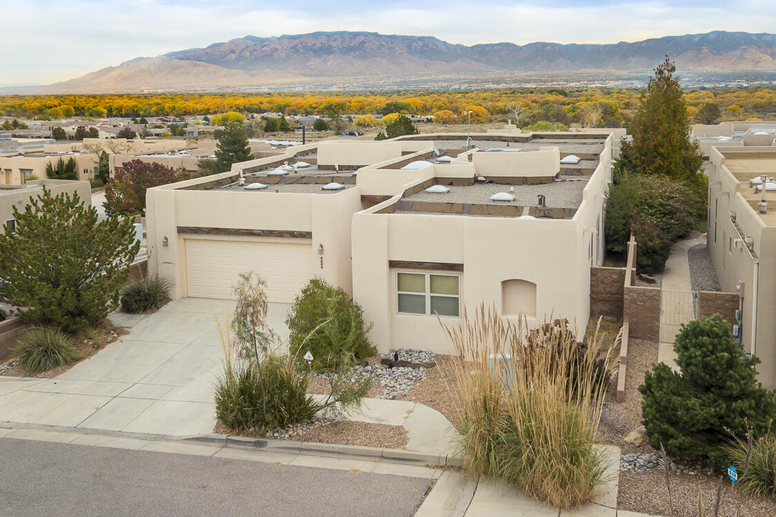 Discover luxury in this exquisite Scott Patrick designed home, featuring an open living concept that maximizes space and stunning views of the Sandia Mountains. The large primary suite serves as a tranquil retreat, complemented by high ceilings that enhance the airy feel throughout. The remodeled kitchen and baths boast modern finishes, making them both stylish and functional. Step outside to your outdoor kitchen, perfect for entertaining and enjoying al fresco dining against a picturesque backdrop. With a spacious 3-car garage, this home perfectly balances elegance and practicality.