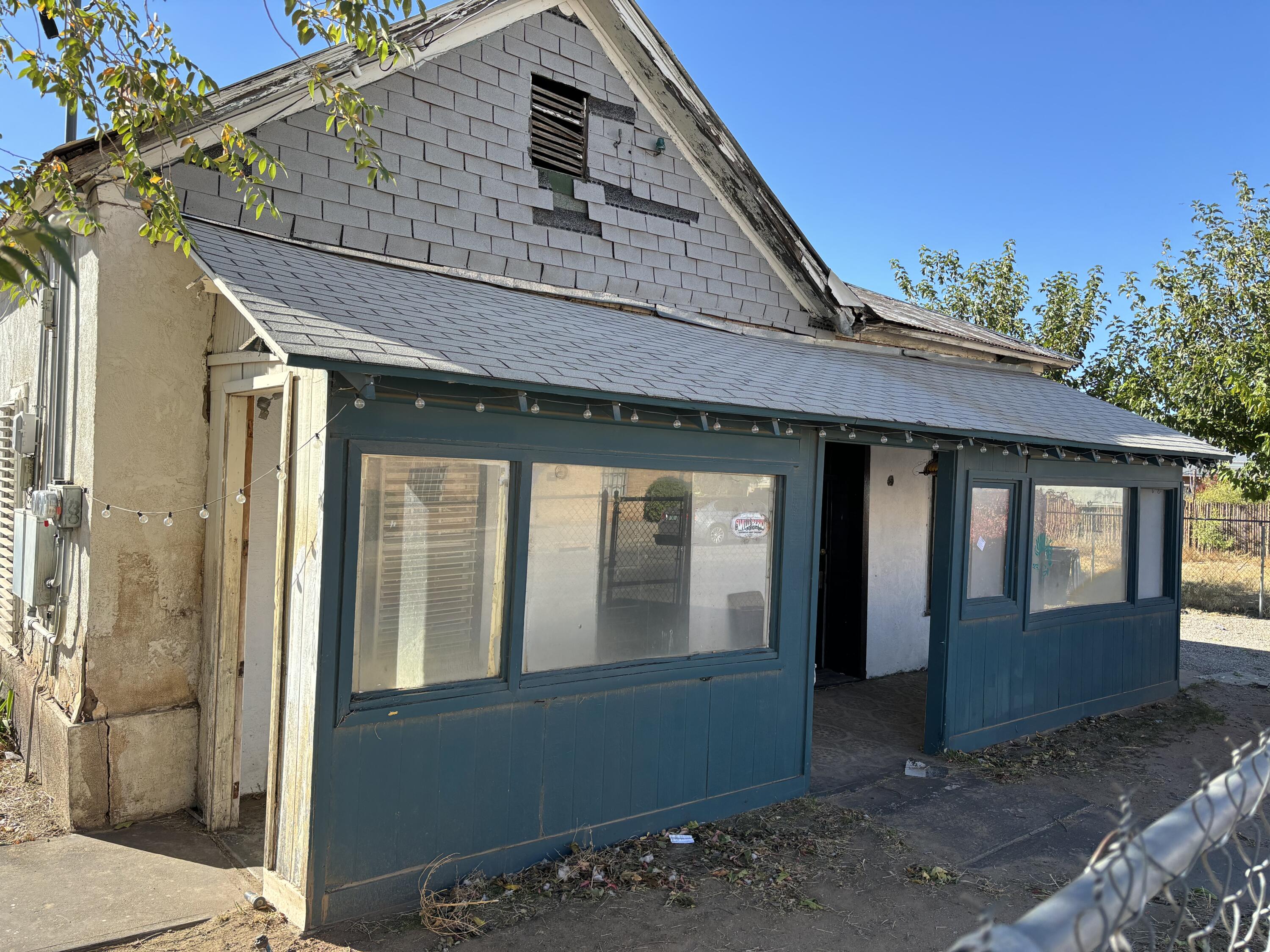 This property was a single family home originally built in 1904.  The home has multiple additions over the years.  The kitchen was removed. The building was used as a screen printing business.  The structure is in poor condition with the lack of ceilings in the back portion of the building.  The floors are uneven. There are large cracks in the exterior walls of the structure. The metal roof is in poor condition.  Selling the property ''as is'' with an Hold Harmless agreement..  Great location near Old Town, Sawmill district, downtown and seconds away from I40.  The sale of the property is made on an ''as is'', ''where is'' and ''with all faults'' basis and seller makes no warranties or representation, express or implied or arising by operation of law, including any warranty of condition