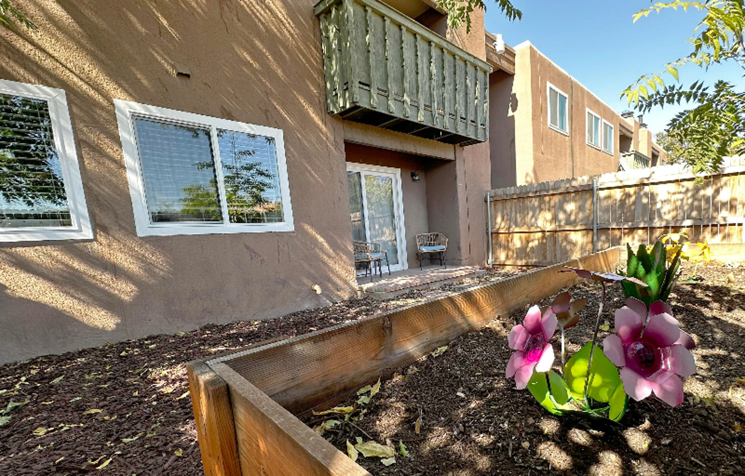 This first-floor corner unit condo in the heart of Albuquerque has been beautifully updated with extensive 2023 renovations. It features brand new windows, a rear sliding door, front door with keyless entry, and luxury vinyl plank flooring throughout. The kitchen boasts new granite countertops and cabinets, with all appliances replaced. The bathroom is fully upgraded with a new vanity, custom shower tile, and toilet. The HVAC system (with Nest thermostat) and water heater are both under 2 years old. Freshly painted with new trim and a refinished fireplace. The secluded yard includes a covered back patio and a fence less than 2 years old. Move-in ready with modern updates!