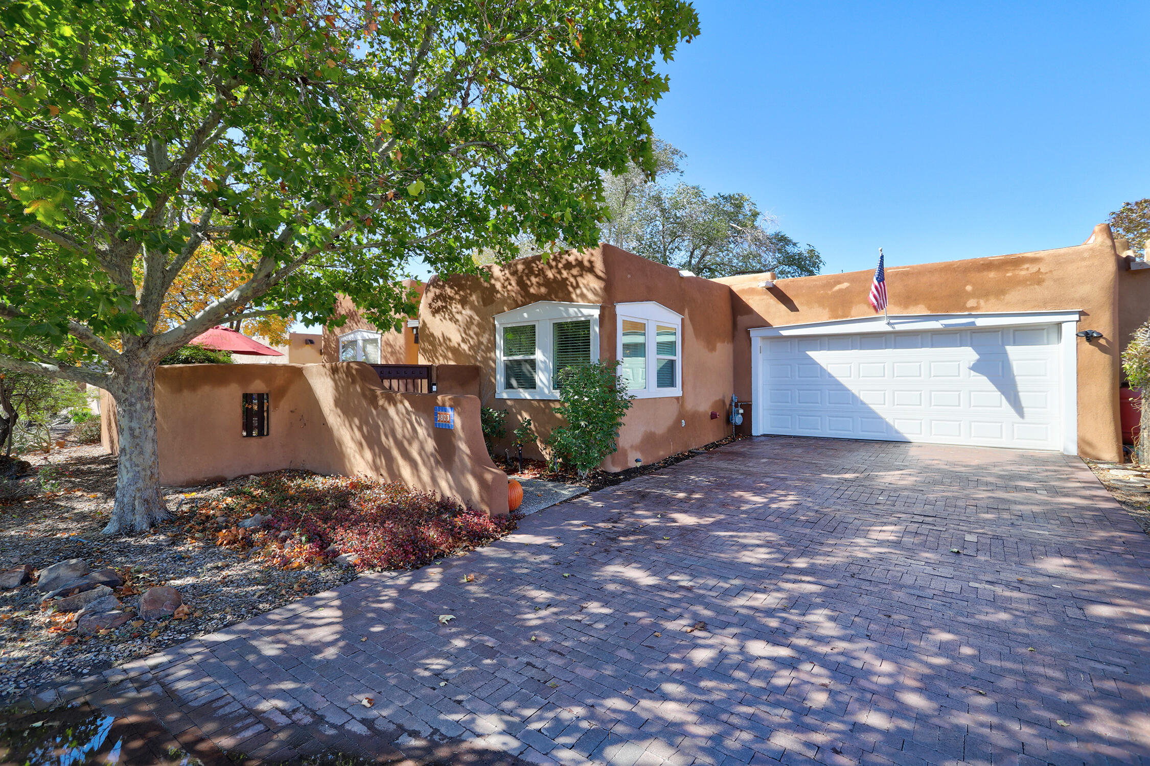 This gracious home at the end of a cul de sac is surrounded by patios and trees, and will dazzle you the moment you step inside. From the heavy beam timber ceilings to the chef's kitchen with bar seating, light flooding in from the skylights, beautiful fireplaces and new designer light fixtures; not to mention formal living and dining rooms as well as a separate TV /family room and an office with flex space, there's beauty and room for everyone. New refrigerated air, partial TPO roof, solid hardwood flooring throughout, granite countertops, sinks and hardware in the bathrooms, all new solid core wood doors throughout, stainless steel refrigerator and wine refrigerator, and Ring camera security system. Quiet street, close to restaurants, bike trails and the bosque. An incredible find!