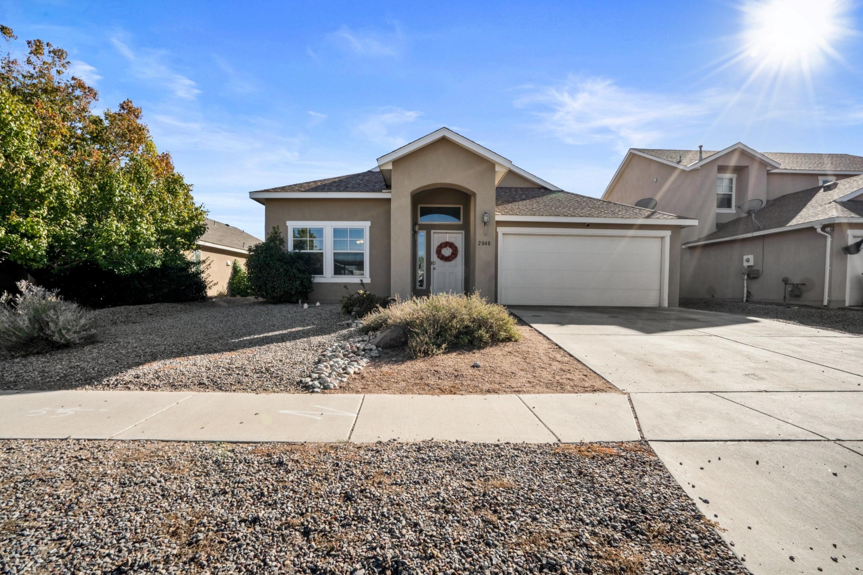 Welcome to 2048 N Ensenada Cir in Rio Rancho! This beautifully maintained home features a spacious open floor plan with modern finishes, perfect for both relaxing and entertaining. The well-appointed kitchen flows into a cozy living area, while a stylish built-in bar adds a touch of luxury for hosting. Generous bedrooms, including a master suite with en-suite bath, offer plenty of privacy. Step outside to enjoy a landscaped backyard, ideal for gatherings or quiet evenings. Located close to schools, parks, and shopping, this home has it all!