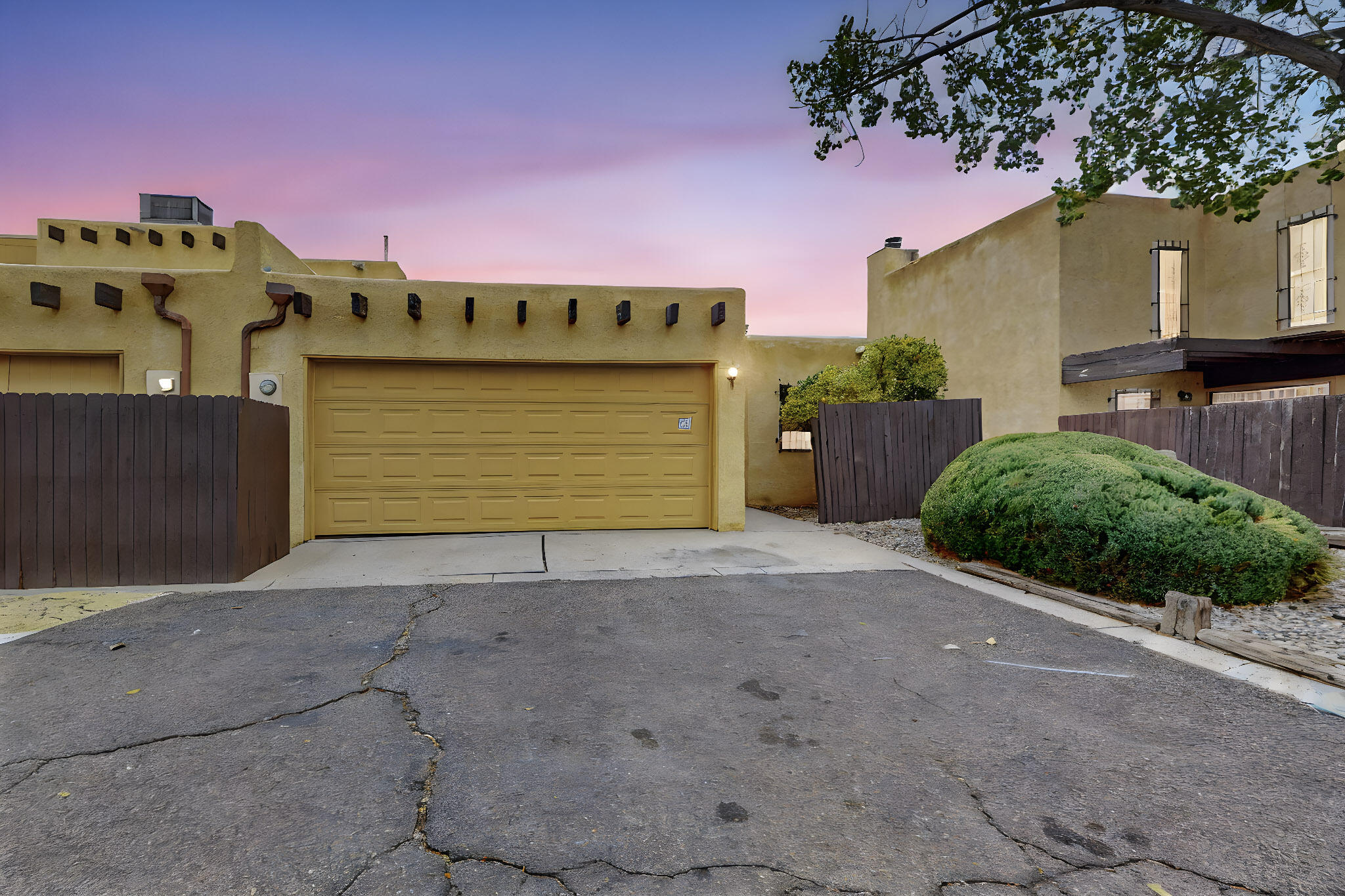 Introducing a charming three-bedroom, 1.5 bathroom home in the desirable Villa Encantada Complex. This unique one-story unit boasts cathedral ceilings and an abundance of windows, allowing for plenty of natural light to fill the space. The townhouse features new flooring throughout, with no carpets for easy maintenance. Enjoy the convenience of a 2-car garage with opener, perfect for storing vehicles and belongings. The corner location adds privacy and a sense of space. The kitchen comes equipped with an electric stove, refrigerator (not warranted) dishwasher and garbage disposal. Washer and dryer convey with the property (not warranted), making laundry a breeze. Residents will also have access to the community pool, maintained by the HOA.