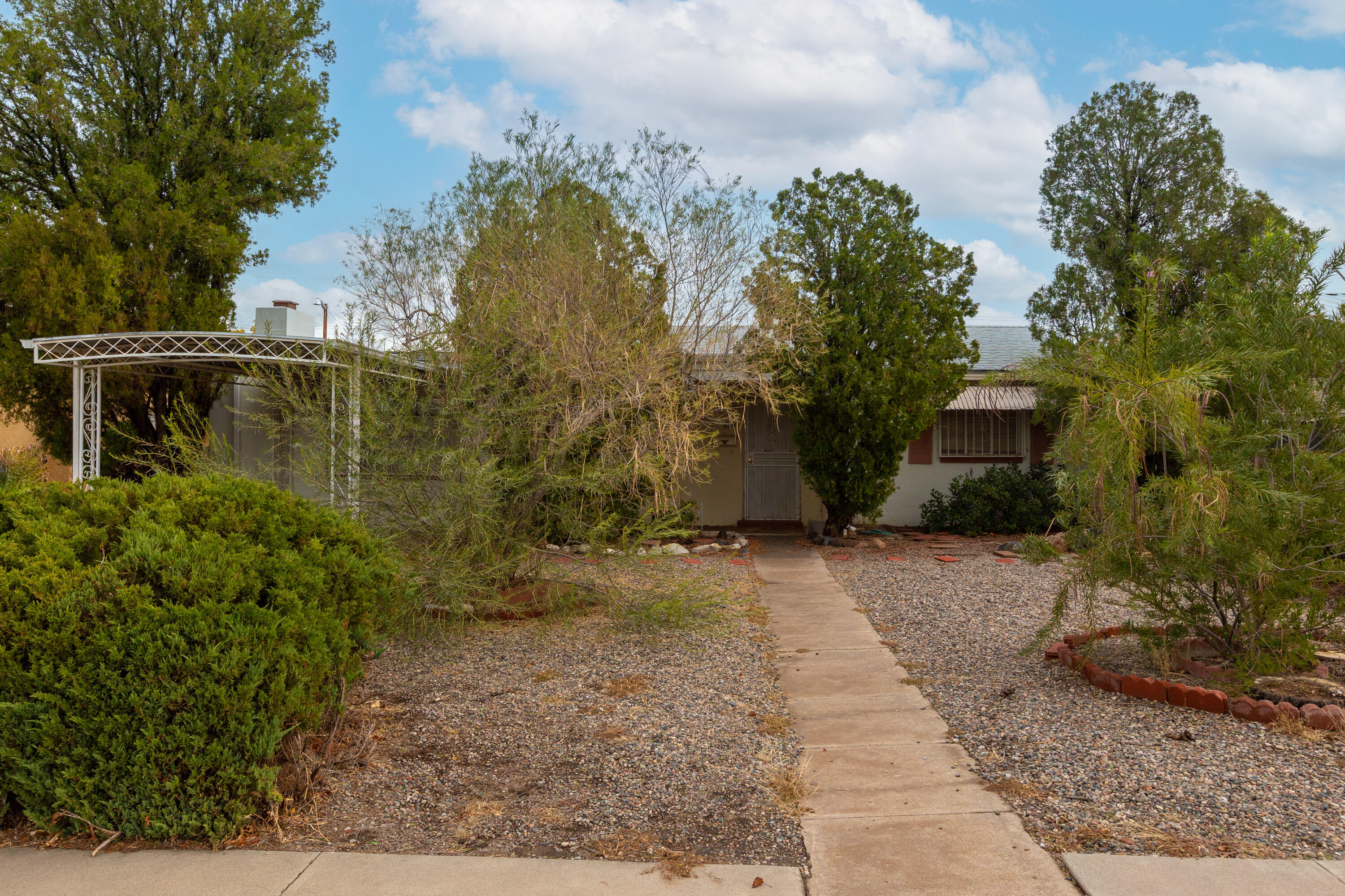 Diamond in the rough, home needs TLC, 3 bedroom, 2 bath home with separated primary bedroom with attached 3/4 bath. Home has been vacant for several months.  Detached two car garage has alley access only.  Covered carport in front.  Security bars on doors and windows,  Needs your loving touch.