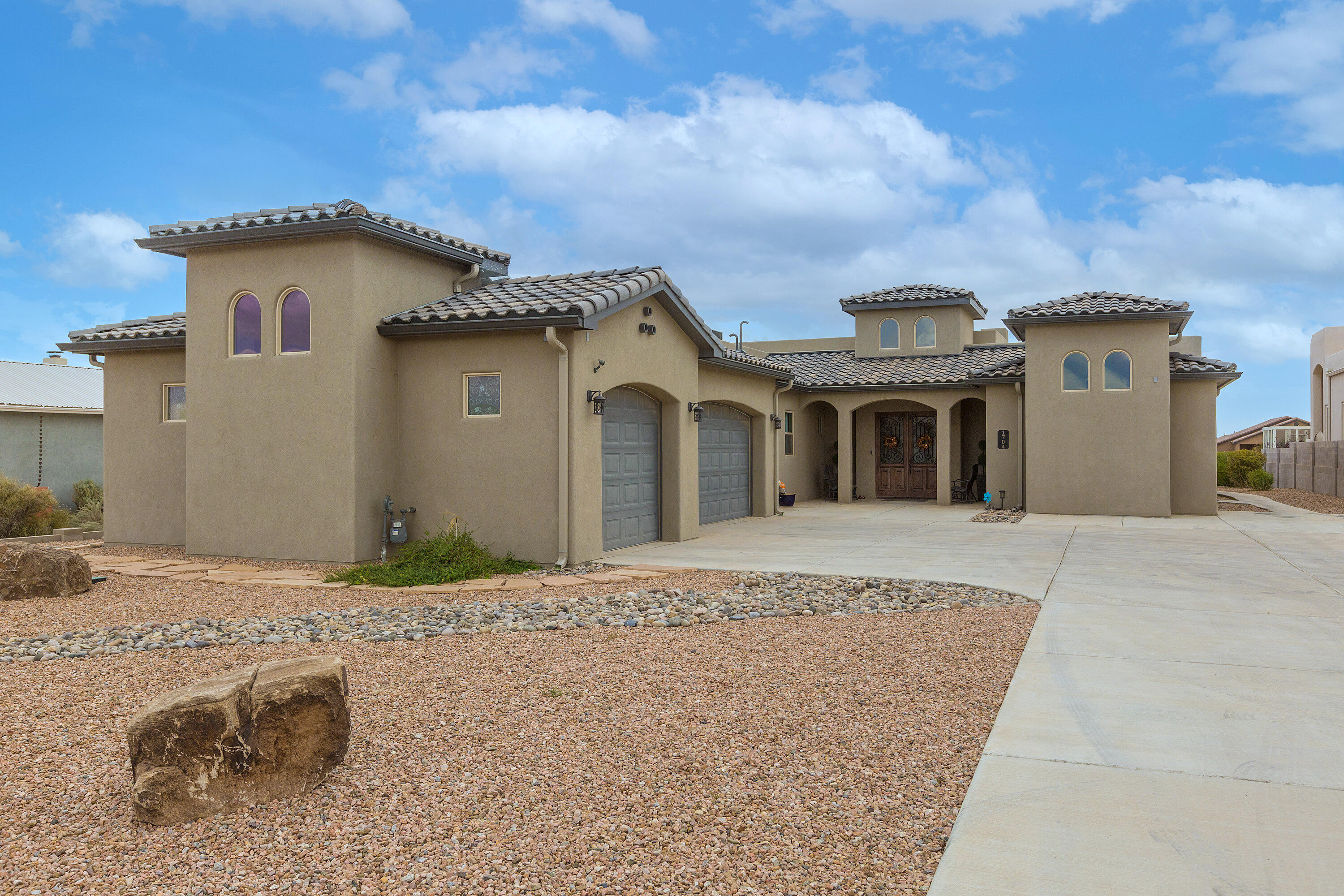 Smartly Placed in Rio Rancho's most sought-after community. Stunning custom Crescent home sits on a spacious 1/2-acre lot surrounded by other custom builds. Spanning 3,014 sq. ft., this 3-bedroom, 2.5-bath beauty offers an open floor plan with a 3-car garage. The gourmet kitchen boasts custom cabinetry, premium granite, built-in oven/microwave, gas cooktop, backsplash, pantry, & an island with seating. The living area features raised ceilings, a gas fireplace, & abundant natural light. Enjoy a bonus/media room for added flexibility. The luxurious primary suite impresses with a tray ceiling, private patio access, spa-inspired bath with dual vanities, granite counters, soaking tub, rain shower, & a walk-in closet. Step outside to an amazing backyard perfect for enjoying breathtaking views!