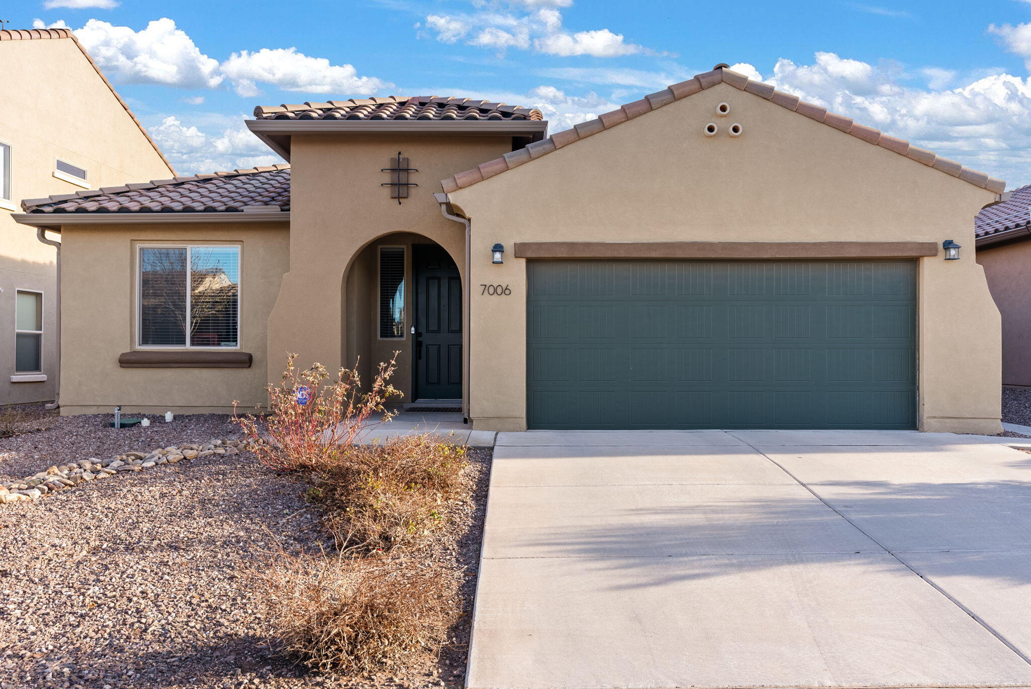 Welcome to this elegant 3-bedroom home, complete with an office, in the vibrant Lomas Encantadas community. This Manzanita Model seamlessly blends style with functionality, offering an open-concept layout where the great room flows into the kitchen and dining area--ideal for modern living and entertaining.  The kitchen is a chef's dream, featuring sleek granite countertops, stainless steel appliances, a cooktop, microwave, and convection oven. Built-in cabinets provide a ready-made workspace for a home office. The spacious master suite offers a separate shower, and a walk-in closet. Enjoy energy savings with fully paid-off solar panels. The 2-car garage includes extra storage or workshop space, covered patio, fully landscaped!! Move-inready, make it yours today!!!