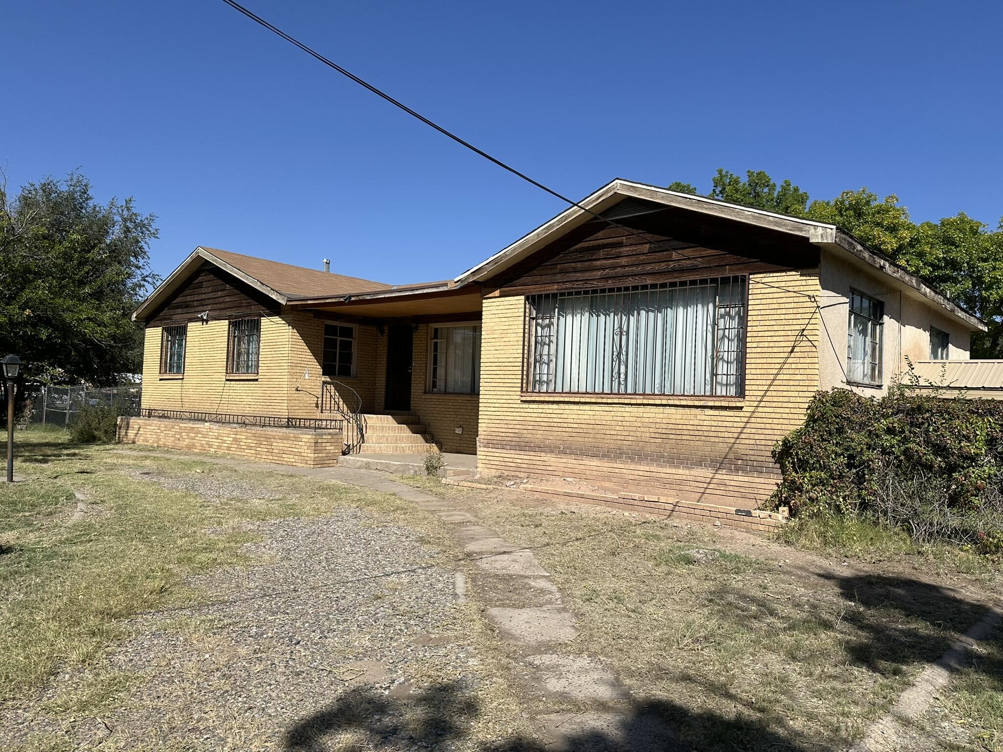 Diamond in the rough, located in South Valley. A 1950's home with old time charm on .62 acres.  Fully fenced, mature trees grace the backyard. 3 bedrooms, 2 bathrooms. One-bathroom updated and other bathroom waiting for your finishing touches. Wood flooring in living room, dining room and bedrooms. Washer & dryer hookups in basement. Back house is substandard and not habitable, not included in sq ft.  Possible workshop/storage/garage attached to back house. The property has endless possibilities, the back house could be transformed into a casita, studio. Non-working well on property. Lots of great space for kids, animals, RV, boat, etc.