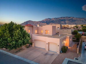 Incredible pool Property with Hot tub cared for and  views of the Sandia mountains/ Breathtaking architecture & gorgeous landscaping Abound in this 3 plus bedroom, 2.5 bathroom  in a cul-de-sac on a corner lot home.  Be greeted by an  Exquisite front walkway .door and foyer with, natural light streams in from the clerestory windows above, leading your  great room with gas log fire place. Kitchen boasts newer Bosch appliances, island and spacious breakfast nook. Butler's entry to the Dining room.  Newer roof, stucco, 2 AC units/furnace and water heater! Primary bedroom is on the first floor as well as an additional bedroom on this floor. Second floor, features loft , views covered in beautiful hard wood, two bedrooms and deck.  North star , Dessert Ridge and La Cueva