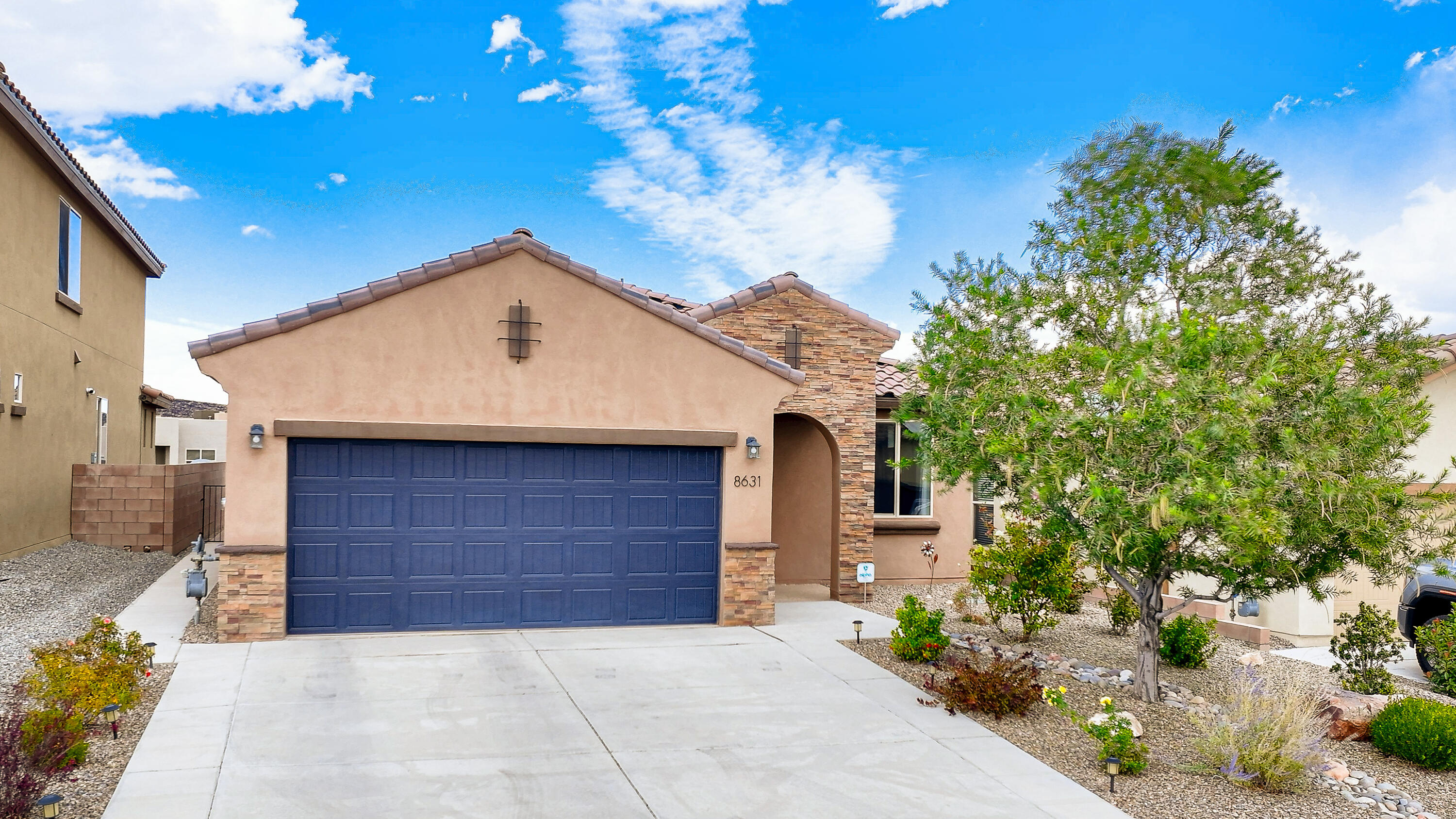 Better than New!!! This highly upgraded single story home has a light and bright open floor plan and backs to the arroyo for additional privacy. Kitchen boasts birch cabinets with soft close doors, upgraded hardware and lighting, granite and premium appliances. Kitchen is open to dining/living area with Rave gas fireplace. Primary suite with large walk in closet and bay window w/ sitting area and mountain views. Primary Bath also has granite double sink countertop. Two generous secondary bedrooms and an office that could be a 4th bedroom. The BY is professionally landscaped with XL covered patio, peach & cherry trees, & more views of the Sandias.  The insulated garage has epoxy coated floors,storage, and an extra two feet deep. Stone veneer, security doors and tankless water heater.