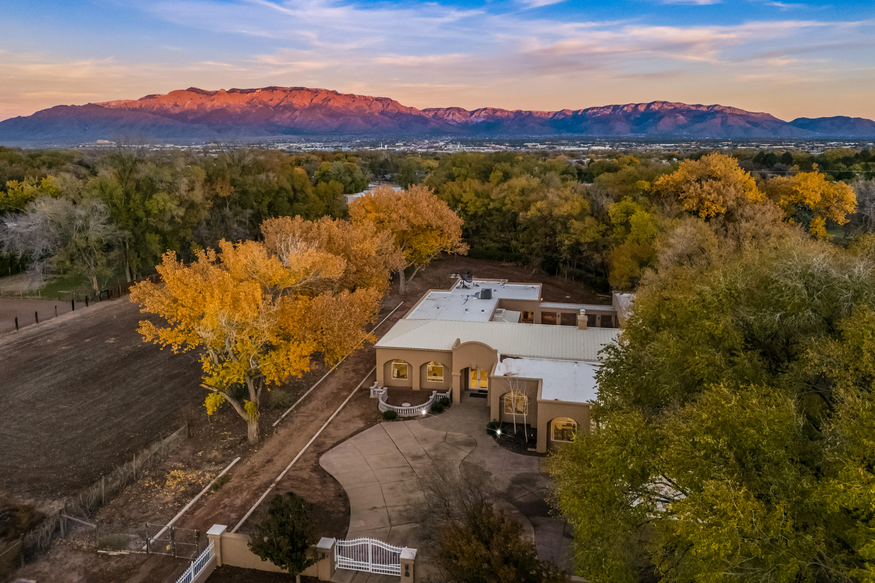 Magical North valley residence! Situated on 1.25 acre w/cottonwood trees surrounding property. Gated entry, fabulous fountain in first courtyard.  Landscaping was the owners next project that he did not get finished.  This makes it a clean slate for your landscaping touch. Wonderful backyard courtyard/outdoor cooking area, and swim spa pool ( w/hot tub/firepit).  Great room w/ FP,  double kitchen island  w/SS Viking appliances, gas stove, a pantry/butler pantry w/pass thru to dining room. Primary suite w/full bath garden tub & steam shower, dbl walk in closet. 2nd& 3rd BR w/large closet. 4th bedroom/Library is perfect for guest bedroom.  3 car garage in front, 1 car garage in back.   Marble tile and carpet flooring.  New stucco, newly painted interior, Pool rehab done, Roof Metal/fl