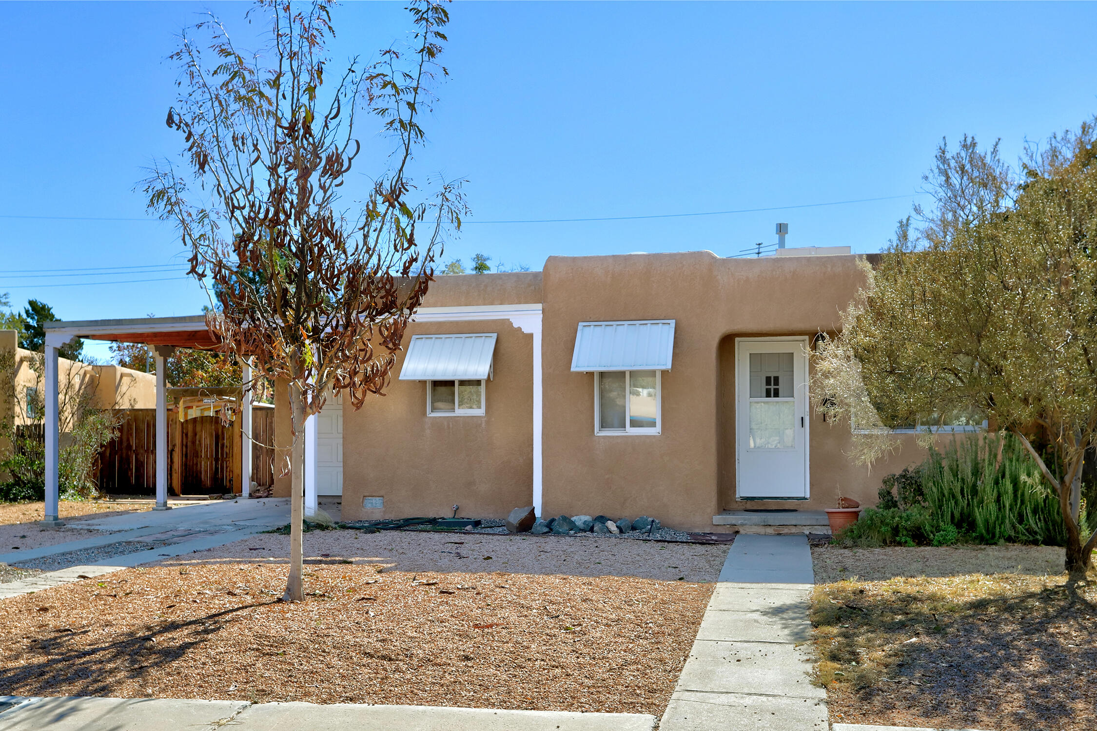 Close to Sandia Labs, Kirtland AFB and UNM. This home has the original wood floors, great sunroom & Casita w/loft. Living room/dining room combo with built-in cabinetry which has been used as an office. Both bedrooms open onto the sunroom. Casita is 436 sq. ft. of living space with a loft and full bath. New insulation in roof, walls and floors Come take a look, plenty of possibilities here!