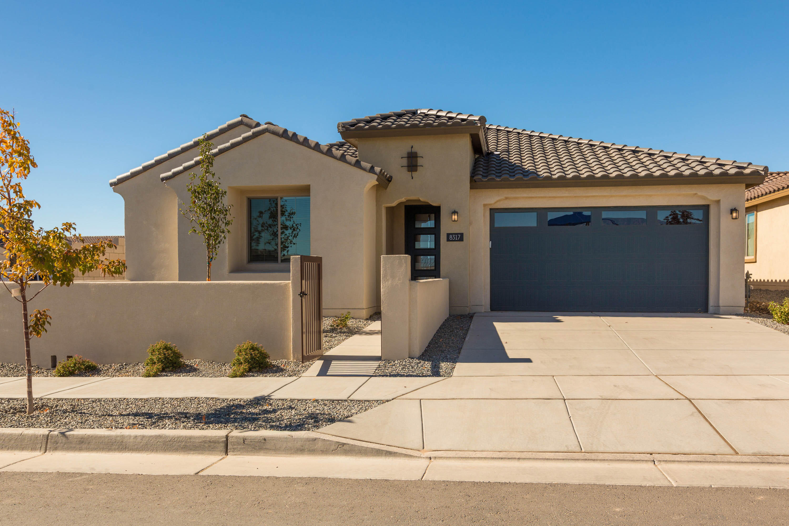 Ready to move in now! The Stella is stunningly situated on a corner homesite across from the park in a gated community. Enjoy the Sandias from the courtyard.  This home features cherry cabinetry, granite countertops, Whirlpool chef kitchen appliances, fridge, a cozy interior fireplace and an exterior one as well. The den with French doors is perfect for a home office or crafts room. Every room has its own walk-in closet. This home is a must see!