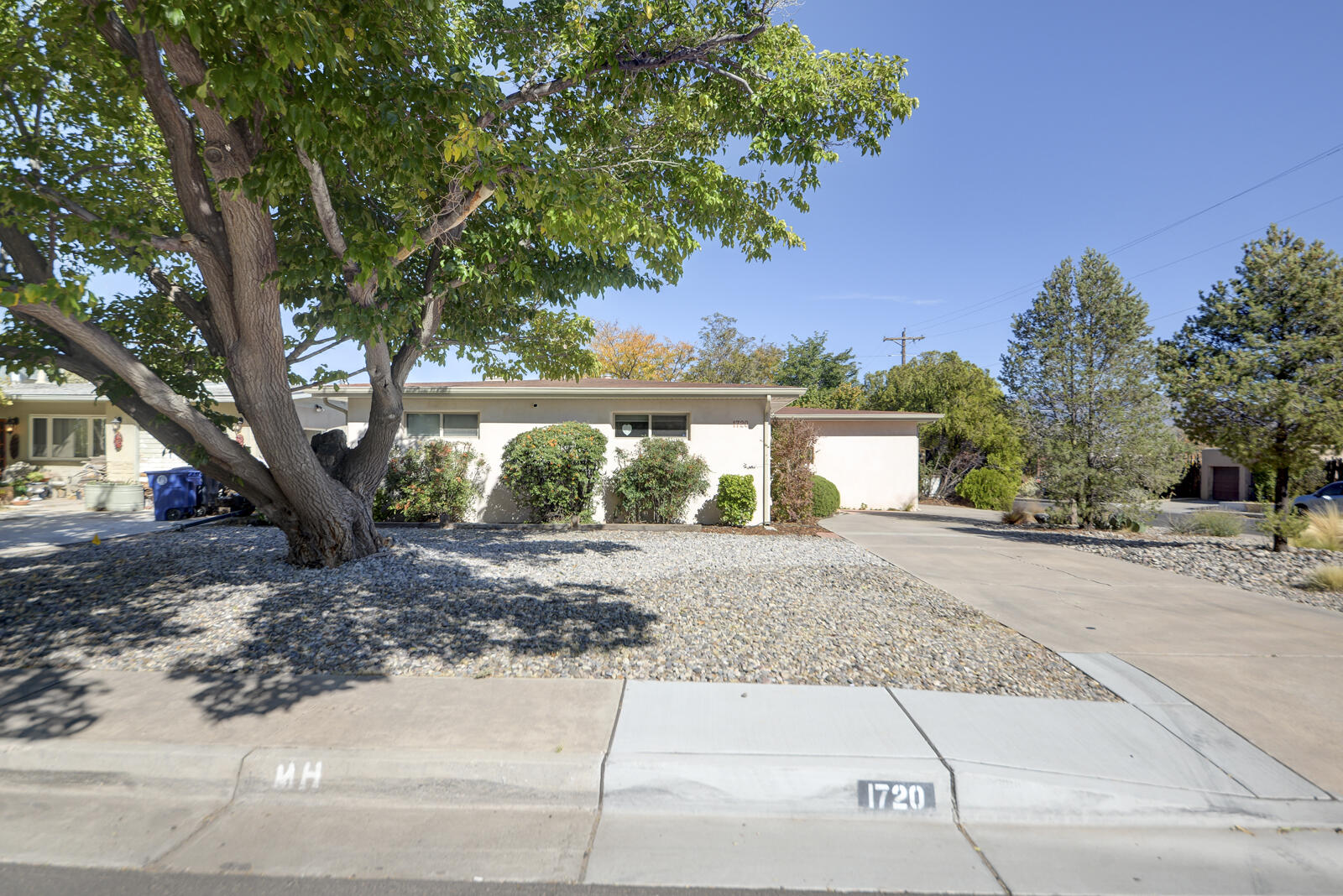 This meticulously cared-for home in desirable Ridgecrest neighborhood offers a blend of modern upgrades and comfort. Added insulation and durable stucco exterior ensure both comfort and cost savings.  A new pitched shingle roof paired with an extensive gutter system adds to the property's  longevity and low maintenance appeal (2020 ), Gleaming hardwood floors run throughout the common living areas and bedrooms,  A Cozy wood burning fireplace flanks the living room/dining room  providing a warm and cohesive aesthetic.  The primary bathroom features a jacuzzi tub, while the hall bathroom has a walk-in shower and new cabinetry for a fresh modern look.  The home has been upgraded with a tankless hot water heater, new plumbing pipes and sewer lines. (see supplement)