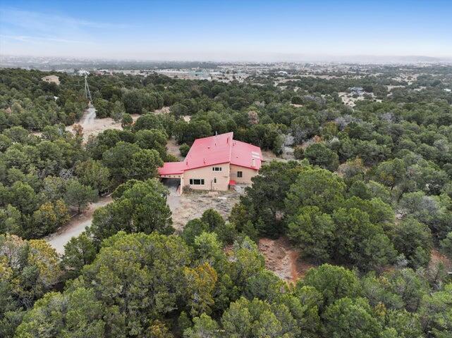 Bring this distressed home back to it full potential! This captivating adobe home exudes warmth and charm with its traditional Southwestern accents, including Saltillo floors, a cozy Kiva fireplace, and beautiful beam ceilings throughout. Enjoy the allure of rounded corners and exposed adobe details on a generous 2.5-acre lot that's perfect for equestrian lovers! Stay warm all winter with not one, but two freestanding pellet stoves and a wood-burning stove. This spacious home offers abundant room for the whole family, with ideal guest or teen quarters and two versatile lofts perfect for an office or workout space. The fully fenced lot, filled with wooded areas and meadows, provides ample space to enjoy the Mtn Lifestyle. Cash Only! Distressed condition-AS IS