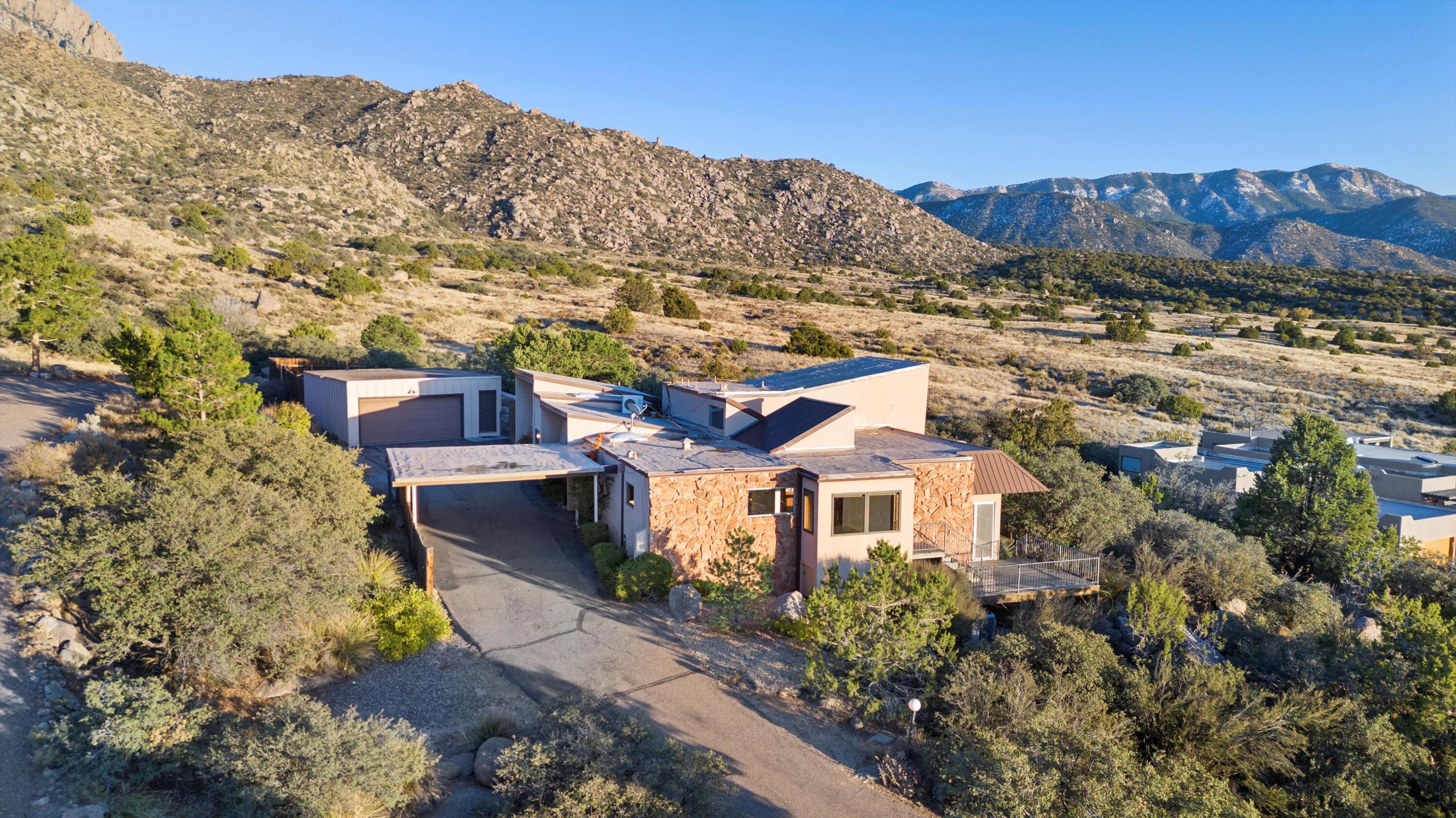 Nestled in the Foothills with Magnificent Views, this Striking Custom Home offers a Combination of Classic Mid-Century Charm, Spacious Living, and Breathtaking Panoramic Views of the Sandias, the Rio Grande Valley Bosque, the West Mesa, and the Albuquerque City Skyline. Whether you Simply Update Flooring and Paint, or Design and Create a Complete Remodel, the Value-Add Potential is Limited Only by Your Vision. Located on a Generous .64-acre Lot, w/ only the Mountains and Acres of National Forest Behind, this Home is an Incredible Investment for the Discerning Buyer. Other Key Features include: Prime Location w/ NO Mandatory HOA Ideal for Multi-Generational Living: Potential Guest/In-Law Quarters with Separate Entrance, Complete with a Bedroom, Bath, and Sitting/Great RoomMORE...