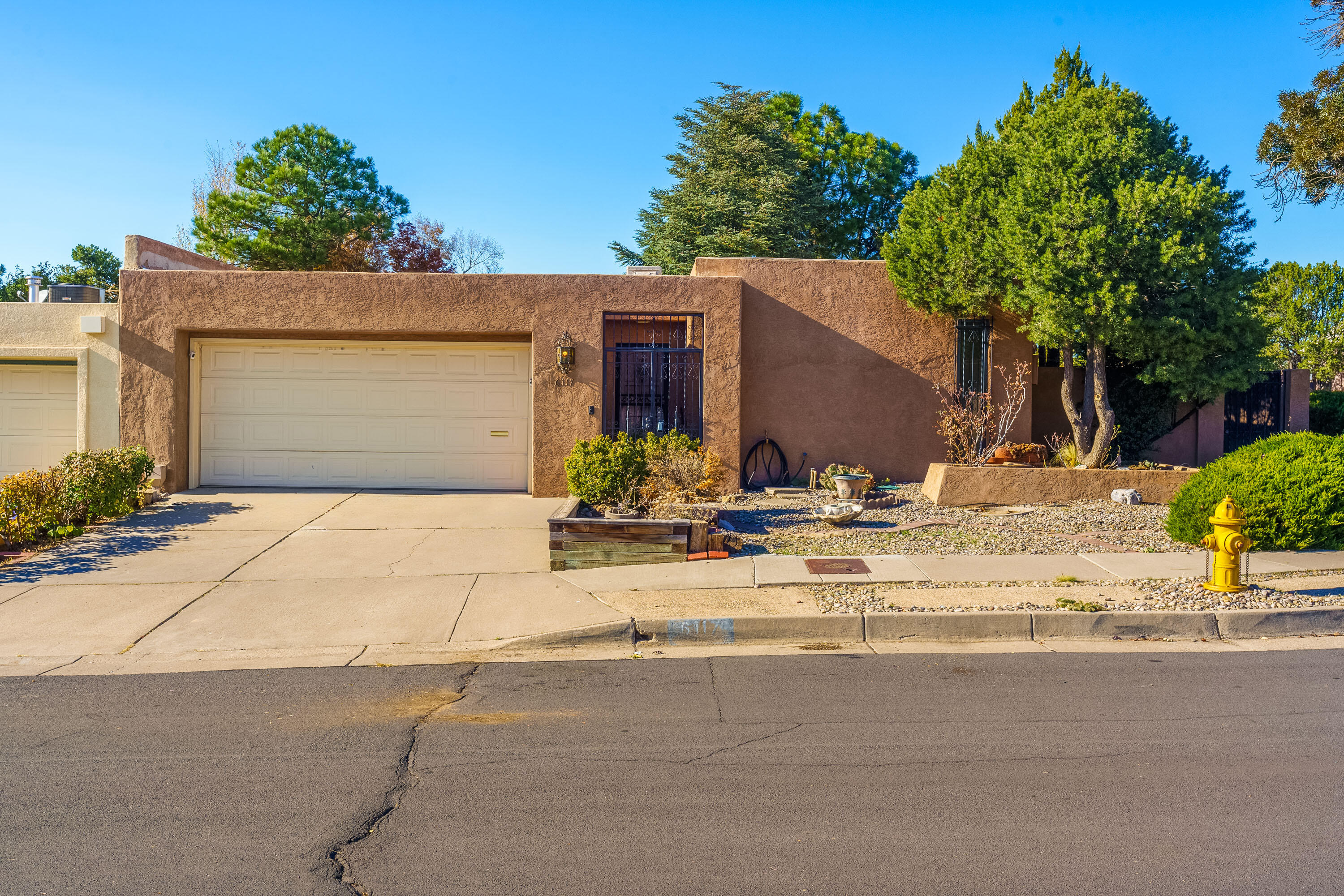 ''Welcome to this Mossman Townhome home in Bear Canyon.  Super Location. This spacious residence boasts two living areas, abundant natural light from skylights, and a perfect blend of flex spaces to fit your lifestyle.  The large, inviting living room features high ceilings and a cozy fireplace, while a separate den/family room offers additional comfort. The generous primary bedroom includes a full bath with separate shower. Outside, the lovely backyard is adorned beautiful landscaping and view of the Sandia Mountains. The location is unbeatable, offering proximity to The Academy, Wholefoods, banks, restaurants, and convenient access to I-25.  Furthermore, this townhouse is attached at the garages only, ensuring that no living space shares a wall for added privacy and tranquility.