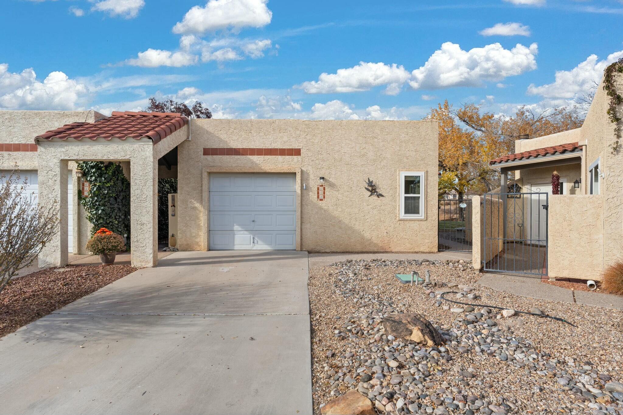 This adorable single level townhome has tons of updates and is ready for its new owner! Walk in to high ceilings and new flooring throughout. Some additional perks are; updated kitchen counter tops and appliances, updated bathrooms and hardware, refrigerated air, garage space and more. Tucked away in a 55+ gated community, this property is close everything you could need. This home has a cozy, modern feel and feels bright and open. Come see this wonderful property today!