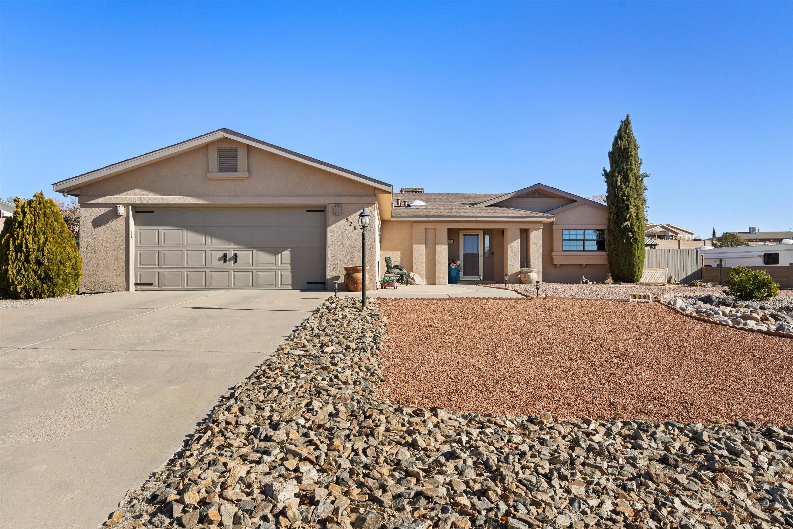 Beautiful single story home in the heart of Rio Rancho with backyard access.  This home features newly installed modern tile, and new carpet in the primary bedroom.  You'll love the spacious kitchen with lots of storage and stainless steel appliances.  Beautiful xeriscaped backyard with a covered patio and syn-lawn.  Side access is perfect for those who have a trailer, boat or just need access for other toys.  Roof was replaced in 2017, and the home has a fairly new Master Cool unit as well for those hot summer days.  Come see this beautiful move in ready home today.