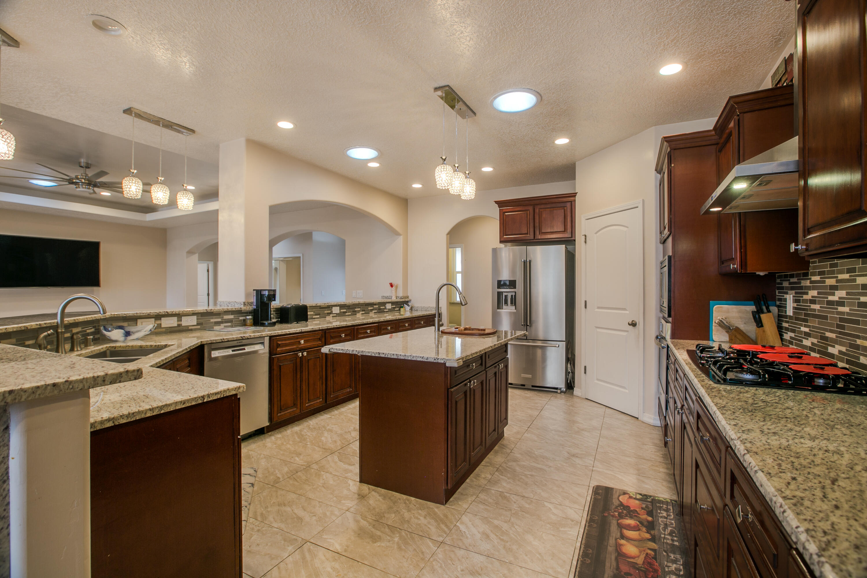 This stunning custom-built home, nestled in one of Bosque Farms' most coveted areas, combines unparalleled craftsmanship with commercial-grade quality. The manicured acreage is perfect for horses, livestock, or creating your dream outdoor oasis, complete with corral space and two chicken coops.  The onsite custom-built shop & storage area features a ''Lift'', a mini gym & dry sauna offering almost endless potential for tradespeople, car collectors, & hobbyists.Inside the home, there are 5 bedrooms, gorgeous tile floors, two high-efficiency HVAC units, a custom fireplace, tankless water heater, energy-saving insulation, and updated appliances.  With NMRGCD ditch rights and unmatched versatility, this property is ready to fulfill your every dream: Livestock? Agricutural? Other? Come See!