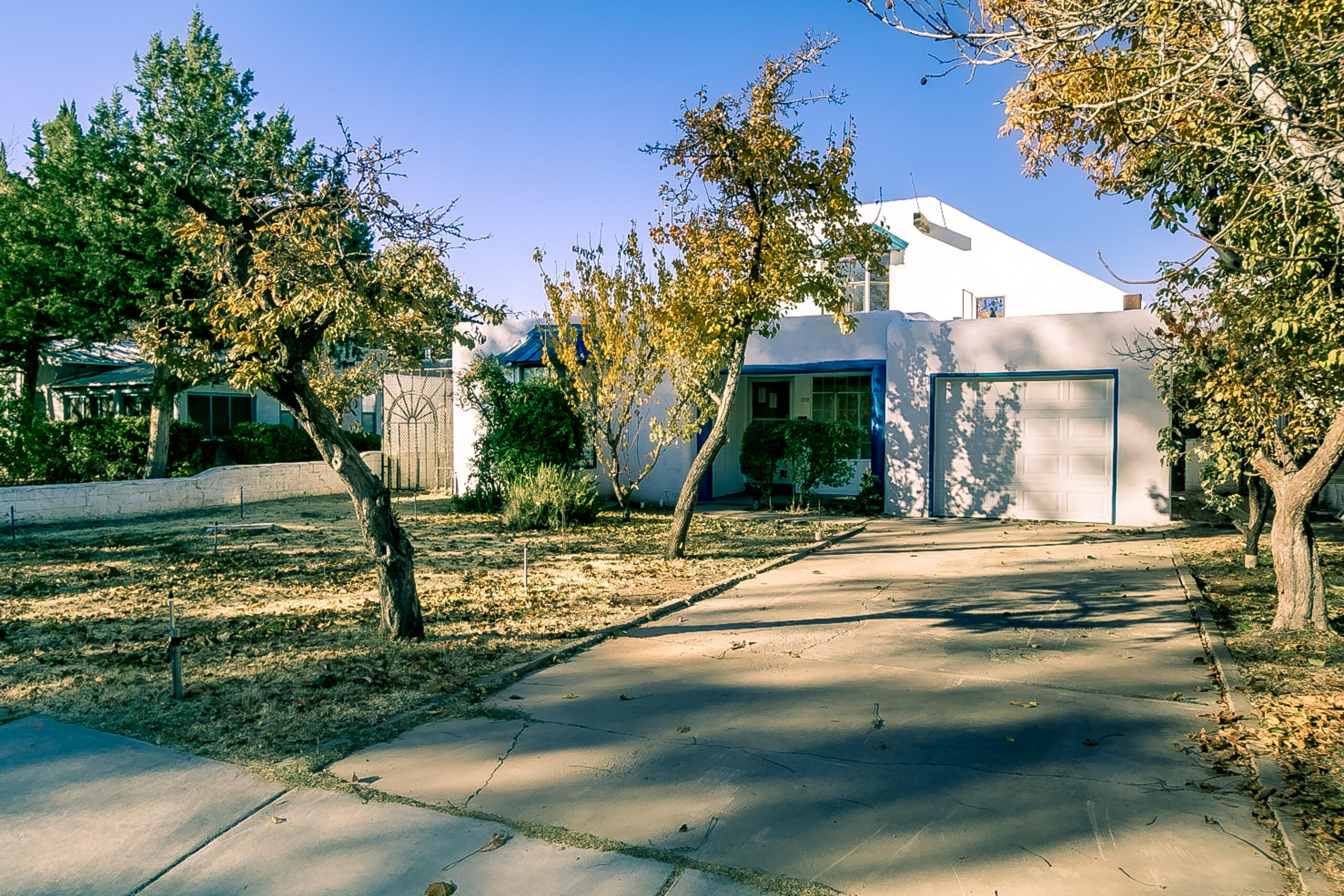 Circa 1936 Nob Hill area house with huge detached workshop (24X20)! New in the last 12 months: roofs, stucco, water heater, evap cooler, 2 mini-splits, refinished wood floors, washer/dryer, water supply lines from street to house, and garage door. Original wide-plank white oak hardwood floors + vigas and stained-glass accents. Open kitchen with cathedral ceiling; fridge conveys. Living, dining and family rooms + loft with floating staircase. Three bedrooms, 1 with kiva fireplace. 1 full + 3/4 + 1/2 baths. Huge detached workshop (24X20) with 10-foot ceilings, 220 electrical, evap cooling and gas furnace. Separate storage bldg. 1-car garage. Laundry room; washer/dryer convey. Thermal windows except historic front living room window. Popular location close to UNM!