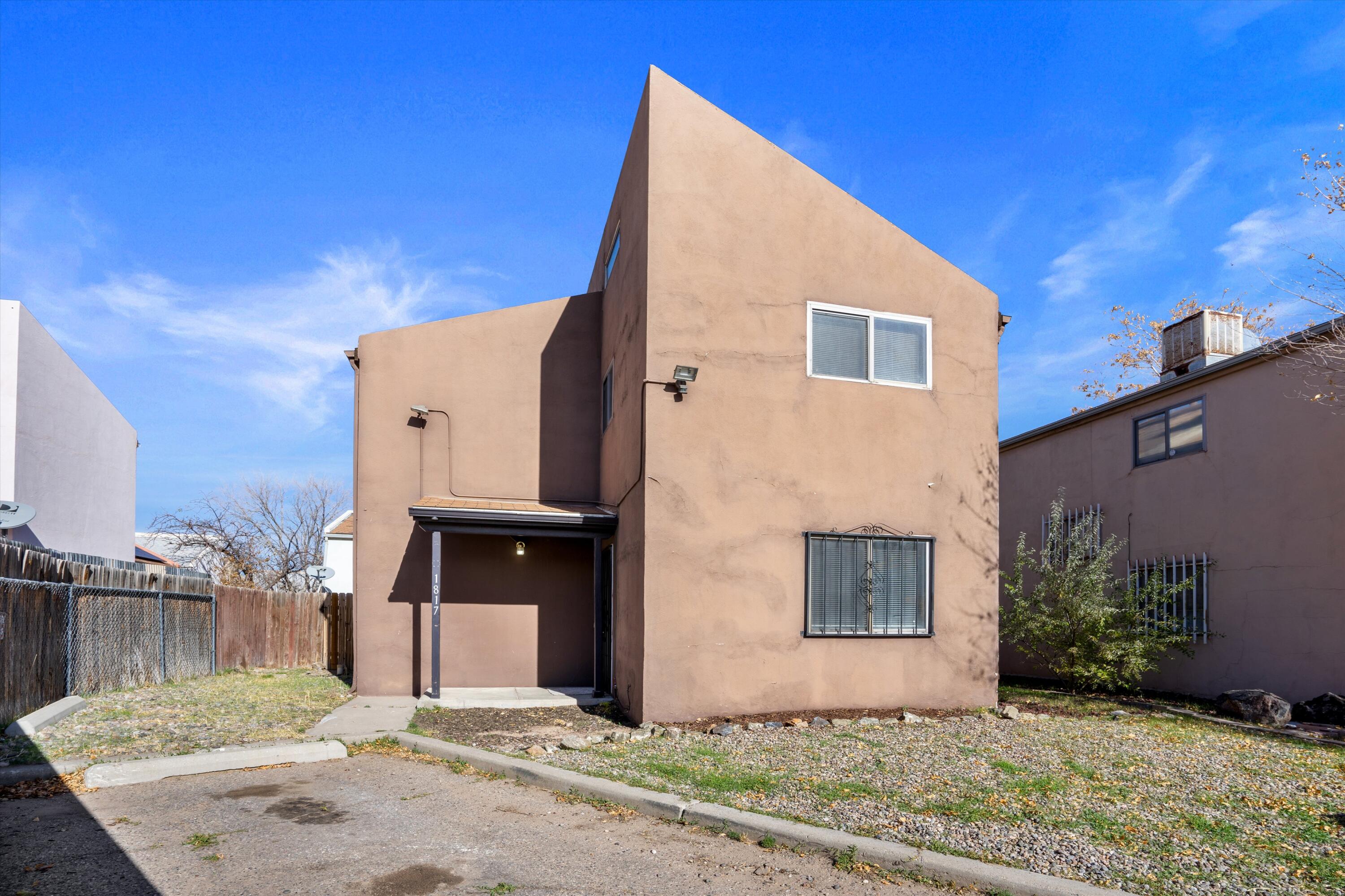 Lovely home in the UNM area with easy access to I-25, situated at the end of the cul de sac.  This home features a large kitchen with a new refrigerator & dishwasher, sink & faucet.  Upstairs you'll find brand new carpet and 3 nice size bedrooms with vaulted ceilings.  Spacious bathroom features a tiled shower.  Brand new roof with warranty just installed, along with a new water heater as well.  Come see this clean, move in ready home today.