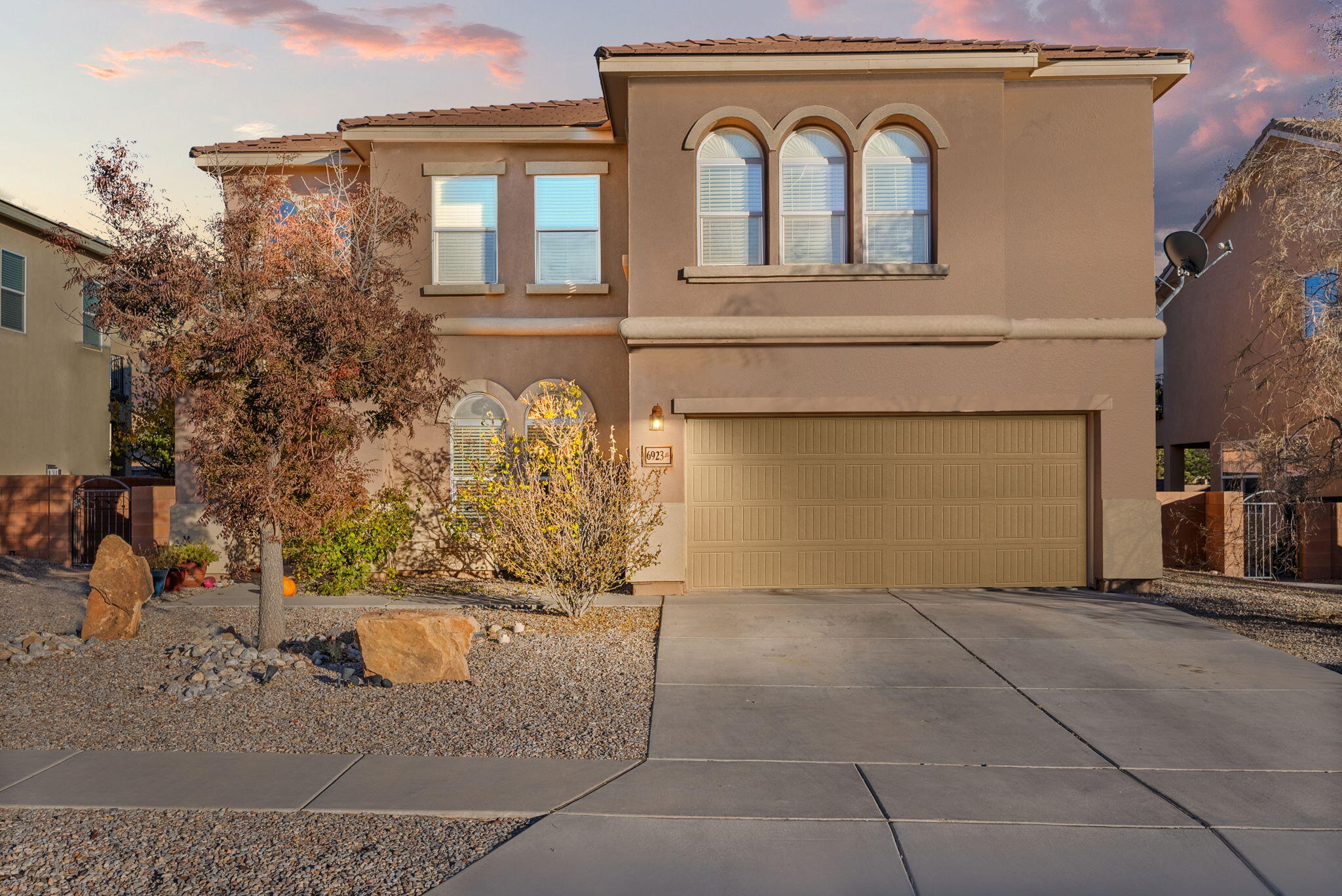 Welcome to this spacious two-story home in Lomas Encantadas, where style meets practicality. The kitchen is a chef's dream, complete with built-in appliances, an island, a walk-in pantry, and a beautiful tile backsplash. Enjoy two living areas, recessed lighting, refrigerated air, ceiling fans, a gas fireplace, and elegant arched doorways, all accented by durable laminate and tile flooring. A convenient laundry room adds to the home's thoughtful design. Upstairs, the master suite is a true retreat, featuring a tray ceiling, private balcony with mountain views, a walk-in closet, and a luxurious ensuite with a garden tub, separate shower, and double-sink vanity. The walled backyard is ready for your personal touch, with a covered patio and ample space to create your perfect outdoor oasis.