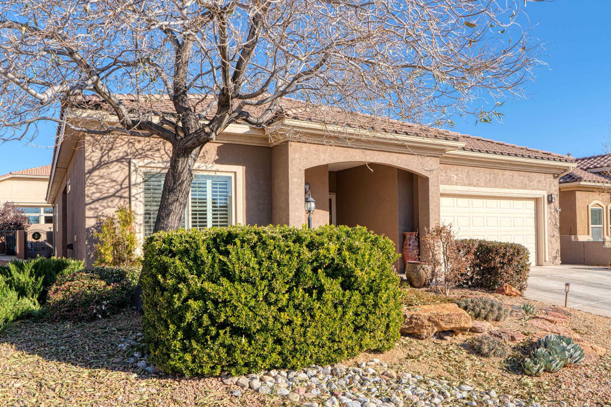 Discover this charming 2,325 sq. ft. Cibola floor plan situated in the vibrant 55+ Del Webb gated community in Alegria. This impressive former Pulte model boasts several upgrades and features an inviting gourmet kitchen complete with an island, granite countertops, and stainless appliances. The open great room blends seamlessly with a cozy breakfast nook and a formal dining area currently utilized as an office. A den adds versatility, allowing for an extra guest bedroom if needed. Enjoy the beautifully landscaped front and back yards, including a private walled yard perfect for outdoor gatherings. Take in the stunning Sandia Mountain views while enjoying the community's wonderful amenities, such as indoor/outdoor pools, fitness center, jacuzzi, and access to the Bosque Trails!