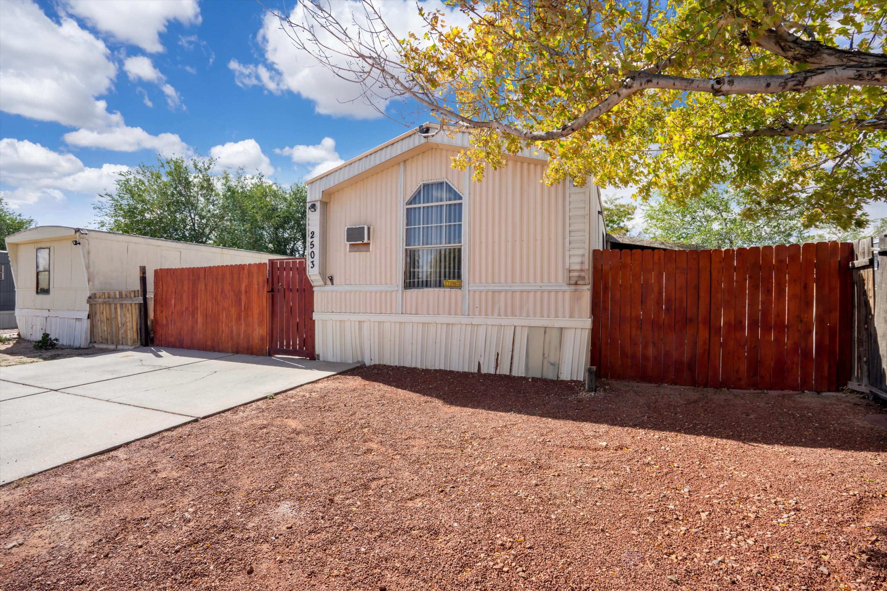 This charming single-wide mobile home offers 4 bedrooms, 2 bathrooms, and a gated yard with a dog door. Enjoy outdoor living with a porch, covered patio, and shed. Inside, the kitchen features updated cabinets, a deco backsplash, an island, and modern appliances. The primary bedroom has a walk-in closet, and the Jack-and-Jill bathroom adds convenience. Highlights include a remodeled bathroom, ceiling fans, a washer/dryer area, a double sink, and a new roof for lasting comfort. Contact the listing agent for details.