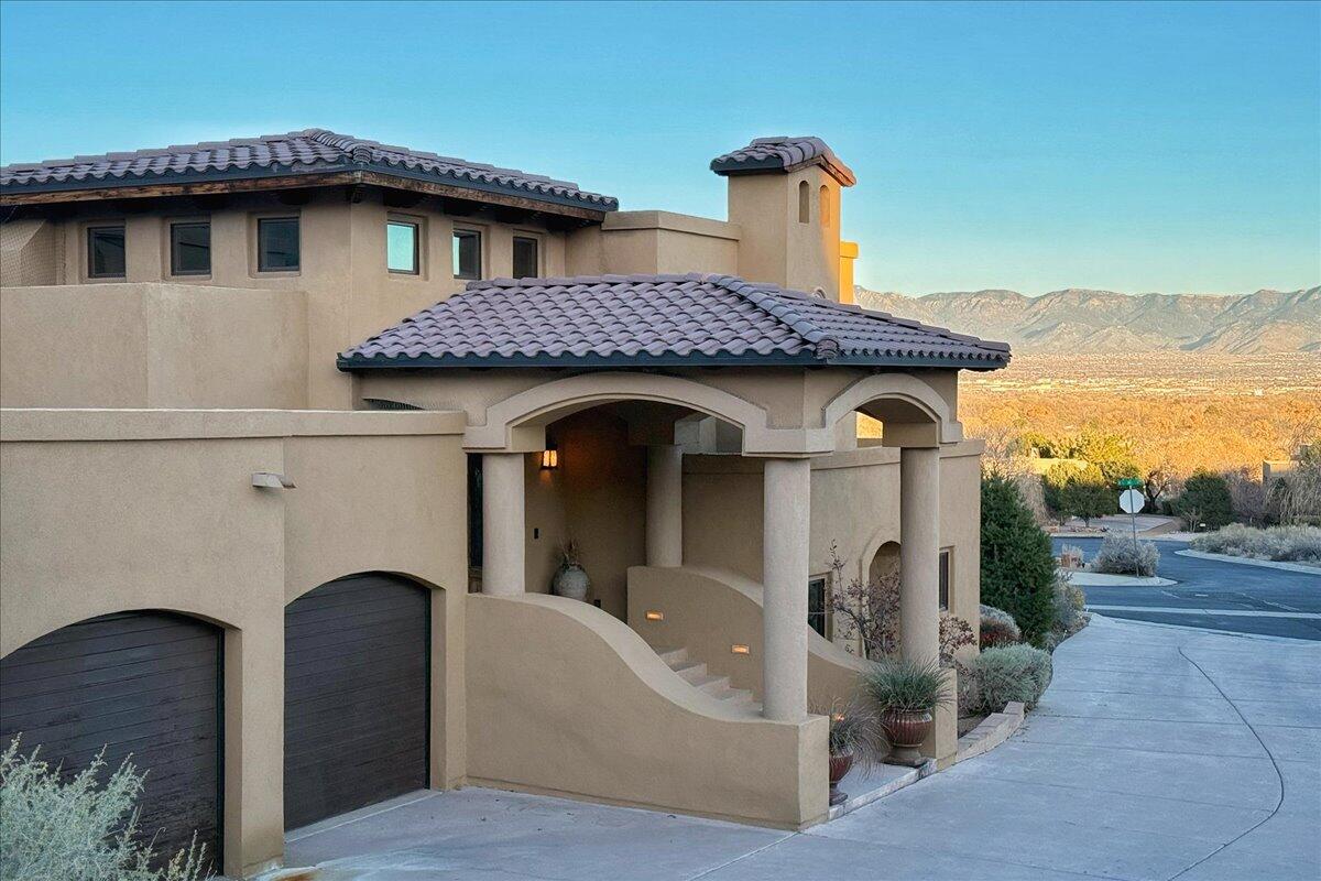 Introducing Casa Bella Vista, aptly named ''home with a beautiful view,'' a luxurious NM/Spanish-style custom residence in Albuquerque's exclusive gated community of Oxbow Bluffs. Situated on a .54-acre lot, this 4-bedroom, 4-bath masterpiece spans 3,645 sq. ft. and offers timeless elegance, breathtaking vistas, and exceptional living spaces.Perched above the Rio Grande, which runs adjacent to the property, Casa Bella Vista provides unparalleled views of the Sandia Mountains, the Bosque, and Albuquerque's iconic skies. The split-level design maximizes these stunning perspectives, with the living room's expansive windows framing the ever-changing hues of the Bosque and the serene flow of the Rio Grande.