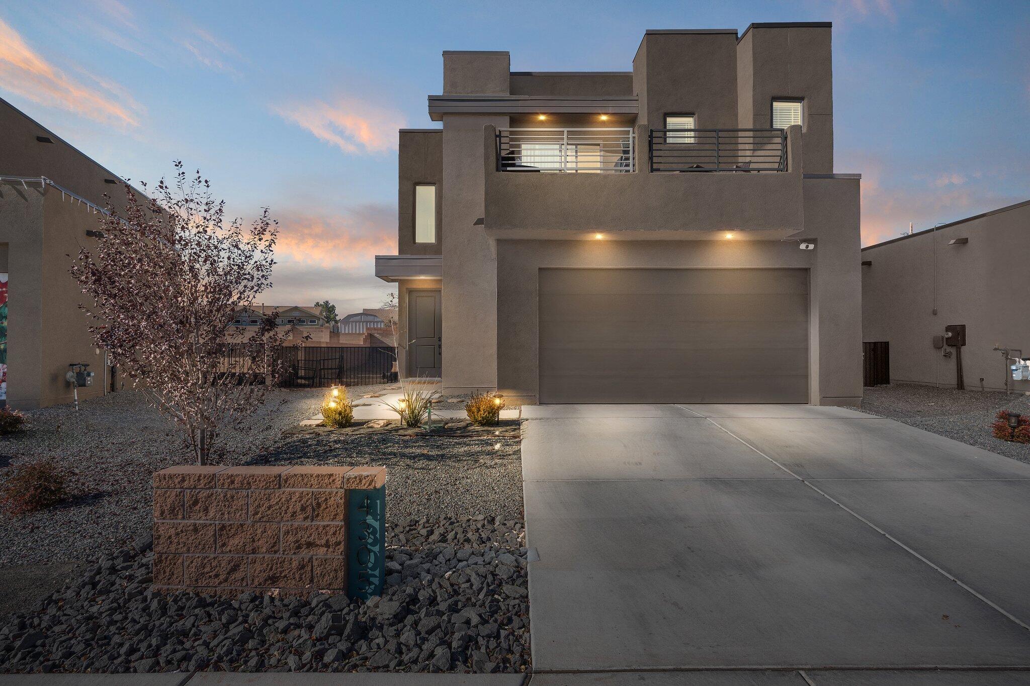 This stunning Abrazo home in Rio Rancho offers style and comfort at every turn! The open floorplan features tile and carpet flooring, recessed lighting, and ceiling fans, creating a welcoming atmosphere throughout. The kitchen is a standout with dark cabinetry, SS appliances, a pantry, and an island with bar seating, perfect for casual meals and entertaining. Upstairs, a versatile loft provides additional living space. The master suite includes a private balcony, walk-in closet, built-in shelving, and an ensuite bath with a walk-in shower and double-sink vanity. The walled backyard with a covered patio offers endless possibilities for your outdoor vision. With a 2-car garage, laundry room, and refrigerated air, this home is ready to make your dreams a reality!