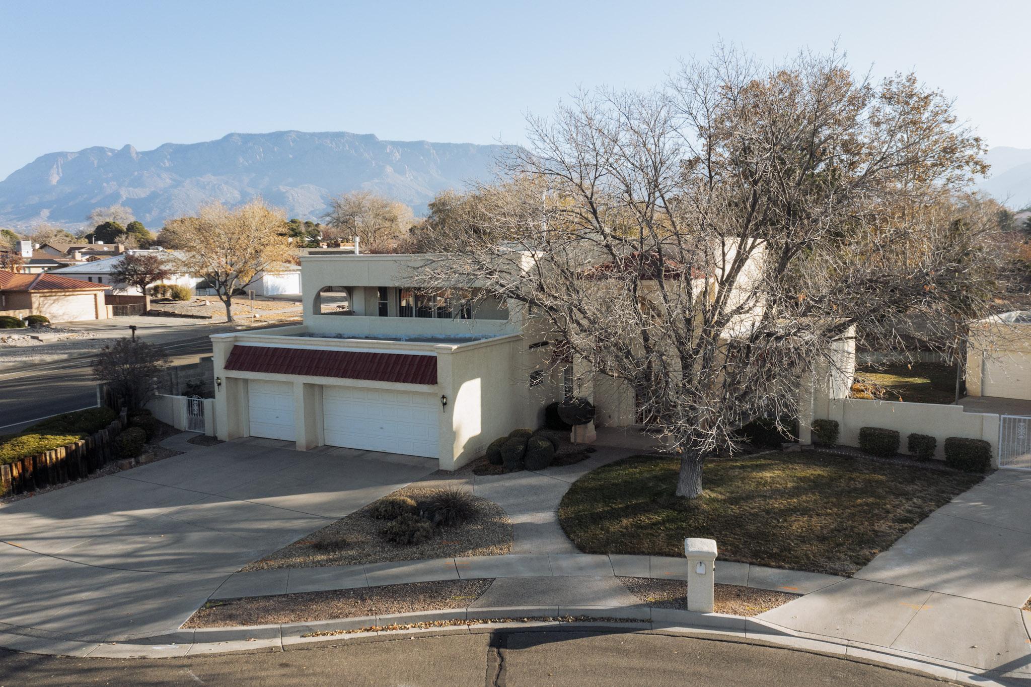 Discover this magnificent 4-bedroom oasis in the esteemed La Cueva School District, positioned on a sprawling .35-acre lot at the end of a tranquil cul-de-sac. The property features an impressive 800 sq ft detached workshop, ensuring both functionality and style, complete with heating. For year-round comfort, the primary residence is equipped with refrigerated air. The expansive 3-car garage offers abundant storage and parking space for your vehicles. Inside, the home dazzles with luxurious granite countertops, seamlessly blending sophistication with everyday living. This extraordinary residence invites you to indulge in modern living while enjoying the serenity of an exclusive neighborhood. Experience the harmonious balance of luxury and convenience that awaits you.