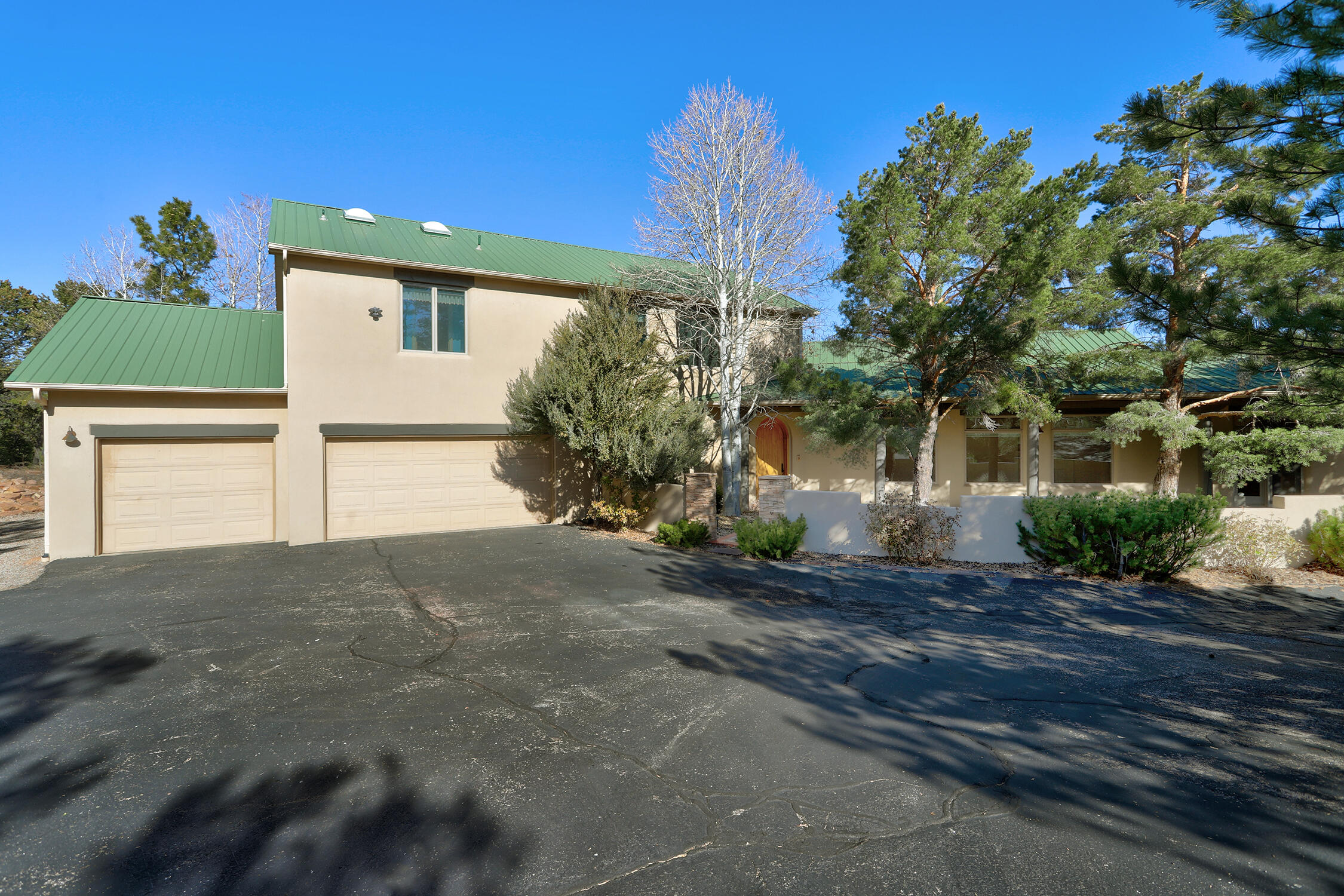Welcome home to your own private 4.7 acre Retreat in the highly sought after Paa-ko Community! Nature abounds around this one-owner home sitting on a double lot. This light-filled home features a wonderful layout great for entertaining both indoors and out.  Primary suite and office (or 4th bedroom), are privately tucked away from the main living areas. As you enter the home, there is a gallery hall to feature your favorite artists' work, and built-in niches and bookcases in the living room to display more treasures. From the second story living area, walk out onto the deck with a view of the Sandias. You will find a vast amount of storage in this wonderful home. The 3-car garage is oversized and contains great built-ins. Enjoy the outdoor fireplace for those crisp evenings.