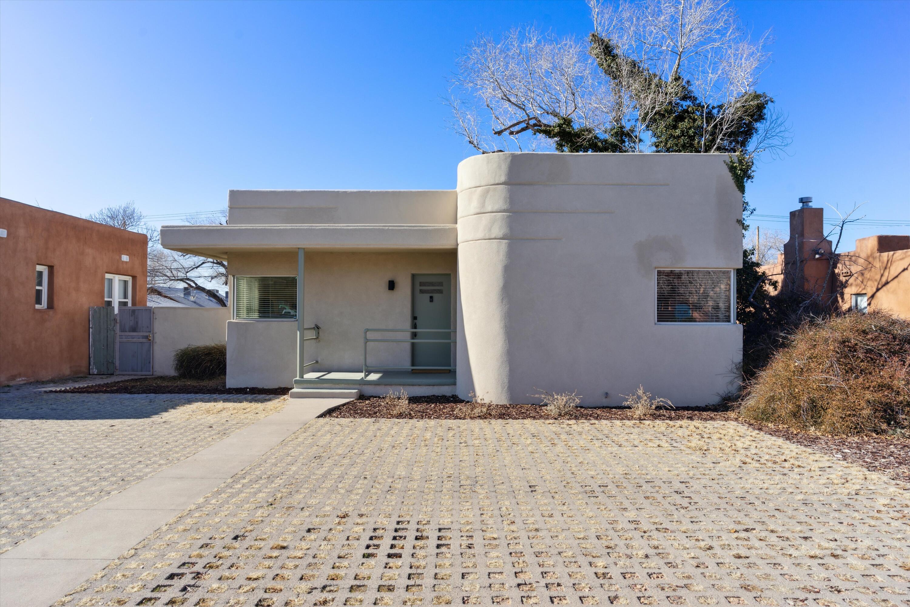 *Captivating 1930s Art Deco Pueblo Home with Endless Opportunities* Step into timeless charm with this beautifully updated 1930s Art Deco Pueblo home, perfectly located near Nob Hill, UNM, top-rated restaurants, shopping, and major hospitals. From the moment you enter, the stunning natural light illuminates gorgeous original hardwood floors, creating a warm and inviting atmosphere. This historic gem seamlessly blends vintage appeal with modern updates. Enjoy the iconic Art Deco facade, built-ins, and classic vintage tile work in the bathroom, updated lighting fixtures, and newer Saltillo tile in the kitchen for a stylish and practical touch. The back yard is a private oasis featuring a covered, Trex wood deck, and hot tub perfect for entertaining. There is convenient front off-street