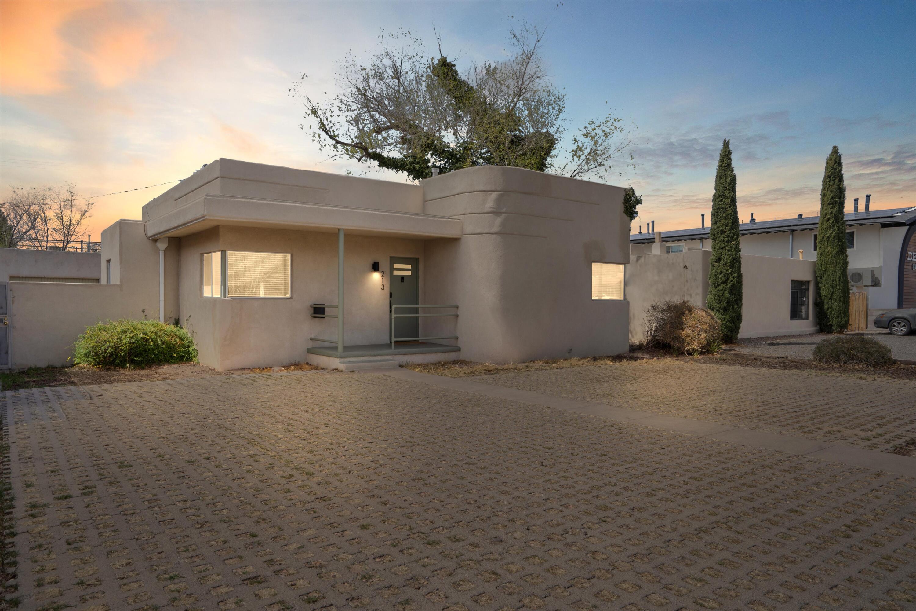 *Captivating 1930s Art Deco Pueblo Home with Endless Opportunities* Step into timeless charm with this beautifully updated 1930s Art Deco Pueblo home, perfectly located near Nob Hill, UNM, top-rated restaurants, shopping, and major hospitals. From the moment you enter, the stunning natural light illuminates gorgeous original hardwood floors, creating a warm and inviting atmosphere. This historic gem seamlessly blends vintage appeal with modern updates. Enjoy the iconic Art Deco facade, built-ins, and classic vintage tile work in the bathroom, updated lighting fixtures, and newer Saltillo tile in the kitchen for a stylish and practical touch. The back yard is a private oasis featuring a covered, Trex wood deck, and hot tub perfect for entertaining. There is convenient front off-street