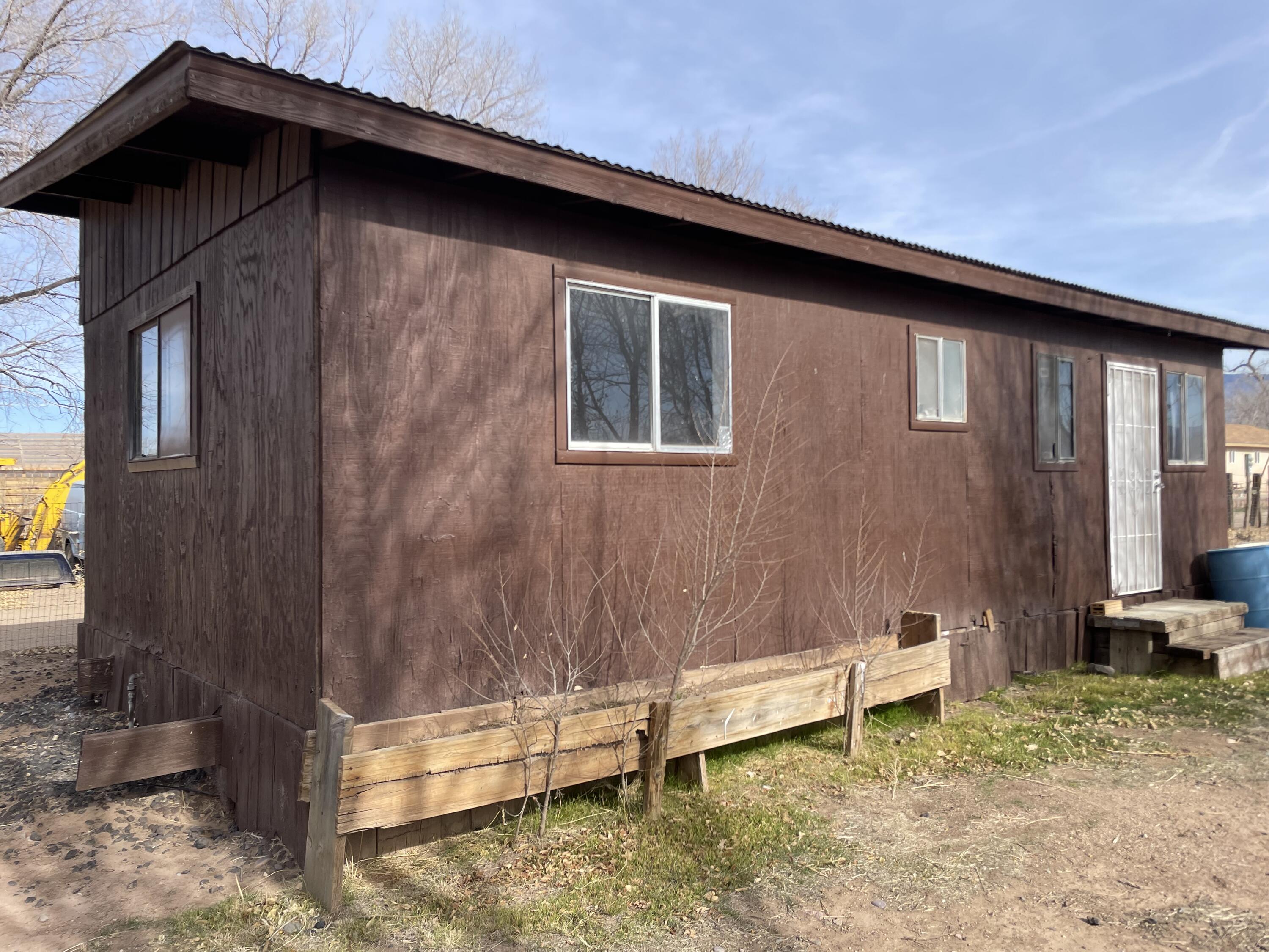 ALL ABOARD!!! Over 1/2 ACRE on the west half of Edith Blvd NE. Pasture your animals, or grow your garden in this stunning North Valley setting! Even in December, natural irrigation is growing wild grass in the pasture! Electricity is connected in the modular home, a 30 amp RV connection on the outside of the home, water is connected (currently shut-off due to a plumbing leak). IRRIGATION RIGHTS may be available. There are two gates leading up to the home which is ready to be updated for a new homeowner, investor, or builder. Agricultural Zoning may allow for many land uses and provide tremendous possibilities.  Fully fenced with the melody of the train in your backyard.