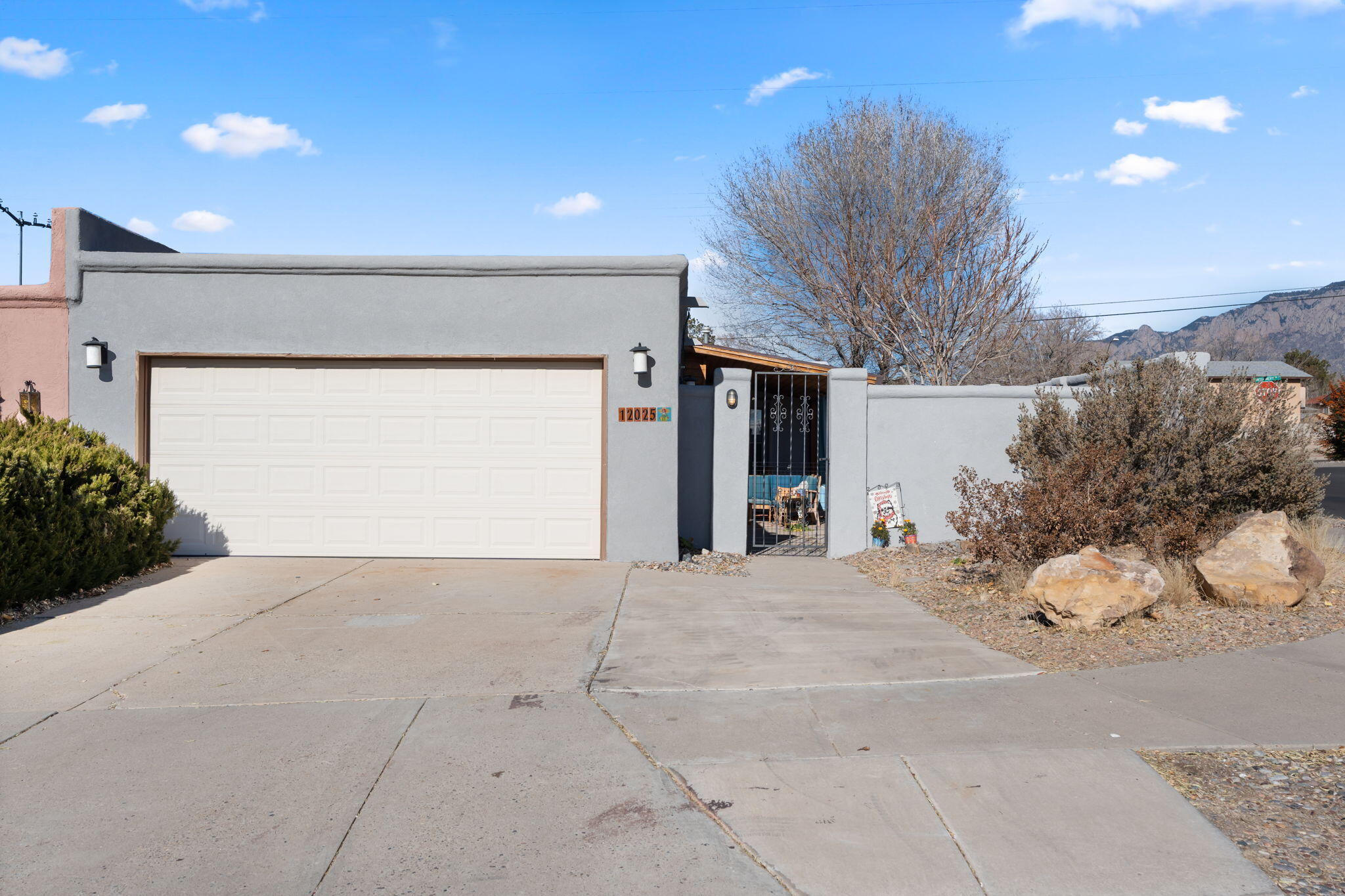 Nestled in the desirable and very convenient NE Heights area of Albuquerque, this beautifully updated townhouse offers a serene living experience, just steps away from the foothills with breathtaking mountain views, and great hiking. The home features a spacious, wide-open floor plan with high ceilings that create an airy and inviting atmosphere throughout.Enjoy the luxury of a low maintenance wrap-around yard and beautiful, private courtyard perfect for relaxation and/or  ideal for entertaining. Additional highlights include a newer swamp cooler for energy-efficient cooling, new wood laminate flooring, and fresh exterior stucco. Come view this charming home with artistic features, stunning views, modern updates, and an amazing location.