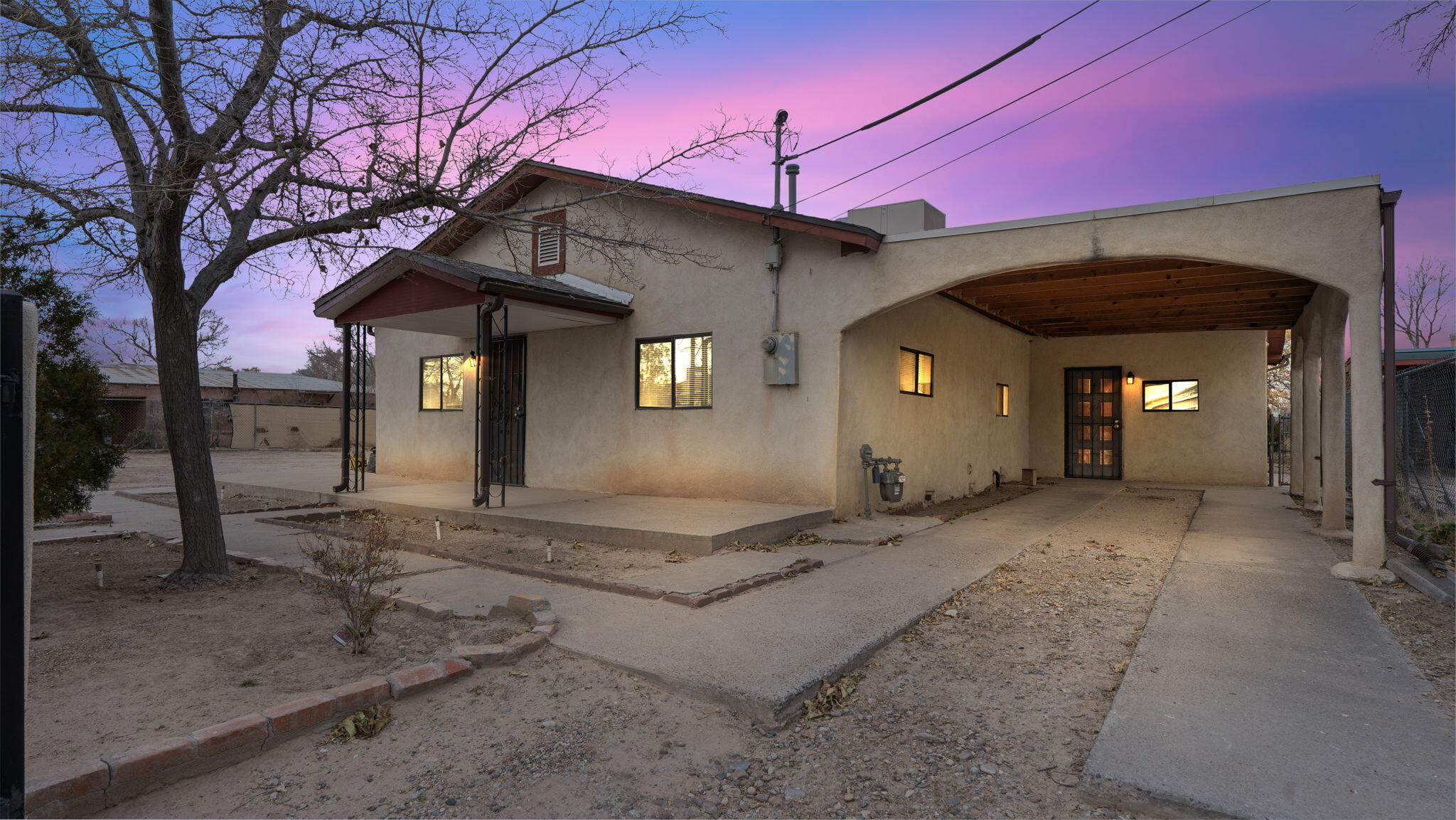 Discover the charm of this 3-bedroom, 2-bath adobe home nestled in Albuquerque's thriving southwest side. Enjoy convenient access to highways, shopping, and a backyard that connects directly to a local park. This home boasts stunning Vigas and tongue-and-groove ceilings, a cozy gas fireplace, and a kitchen updated in 2010 with brick flooring. Additional features include a second building ideal as a workshop or possible apartment conversion, mature fruit trees, and recent upgrades: a new roof (2021), updated plumbing (2010), electrical (1995), and a water heater (2022). Sitting on a .19-acre lot, this property is ready to welcome its new owners.Adjacent Lot is being sold separately. Please review survey included in listing documents.