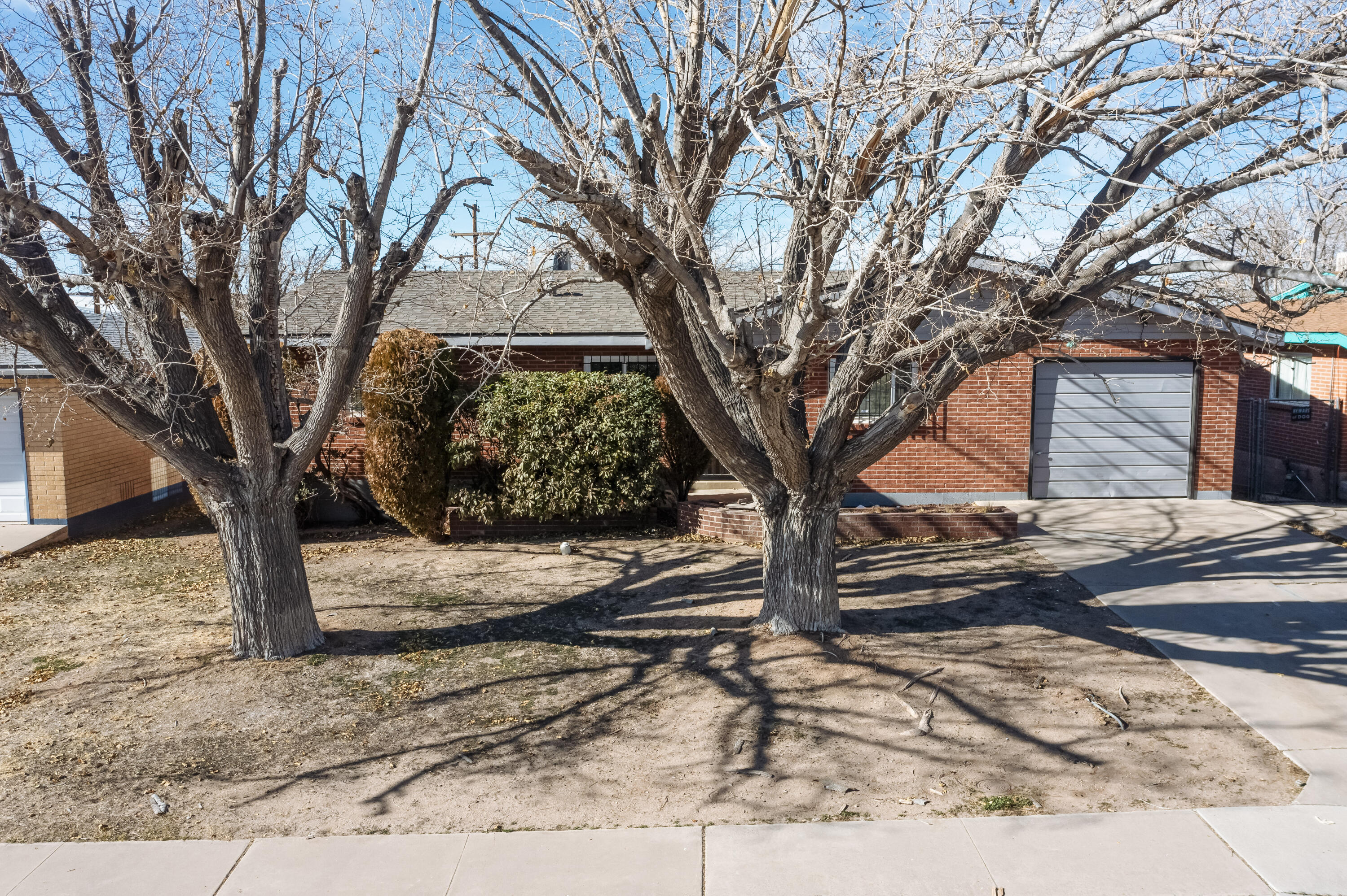 Conveniently located near UNM and The ''Pit,'' this UNM SOUTH GEM offers the perfect blend of charm, convenience, and functionality. Featuring 3 bedrooms, 2 baths, and a 1-car attached garage, the home boasts an open floor plan that seamlessly connects the kitchen to the living/dining room, where a cozy fireplace serves as the heart of the space. Natural light fills the home, creating a warm and inviting atmosphere. Step outside to an expansive backyard designed for entertaining and relaxation, complete with a covered patio, a basketball court, and great city and sunset views. ***No warranties or guarantees are provided. Buyers are encouraged to perform their own inspections for personal assurance.***