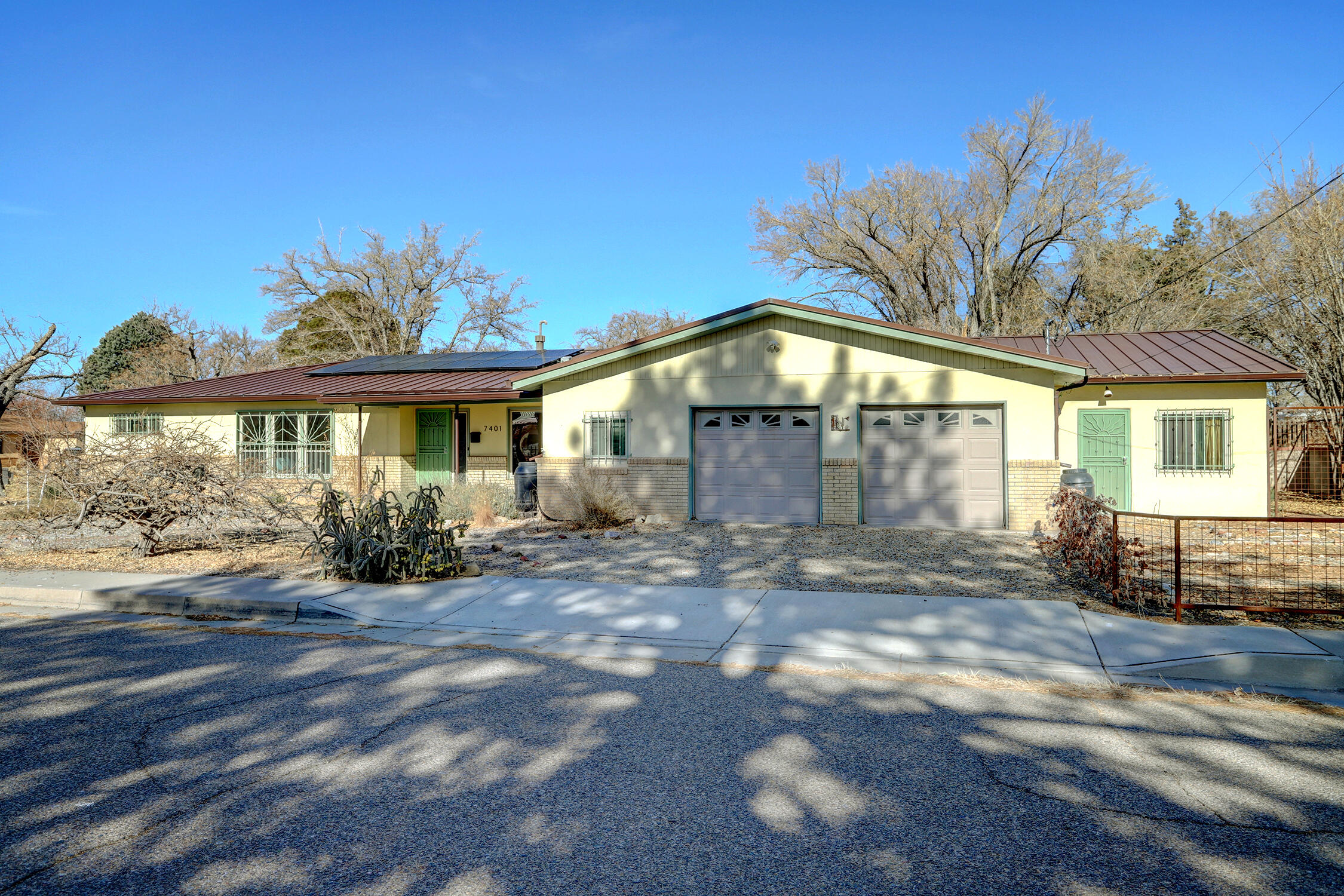 Energy efficiency in this charming Uptown area 3-bedroom, 2+livingroom home featuring a 748sf heated/cooled sunroom. System updates in the past 4 years include a whole-house water filtration system, heat pump, water heater, sewer line replacement, owned solar panels & a durable metal roof! Nature enthusiasts will adore the certified ABQ Backyard Refuge featuring 5 fruit trees, 3 grapevines and dozens of native plants --a true haven for bees & visiting roadrunners! A carpet-free home with beautiful flooring including wood & tile, a stylish kitchen completed with all appliances & a formal dining area highlighted by a large front window. An oversized garage provides a large storage area for crafting, a home gym or workshop. The sunroom, adorned with saltillo tile flooring and its own sink