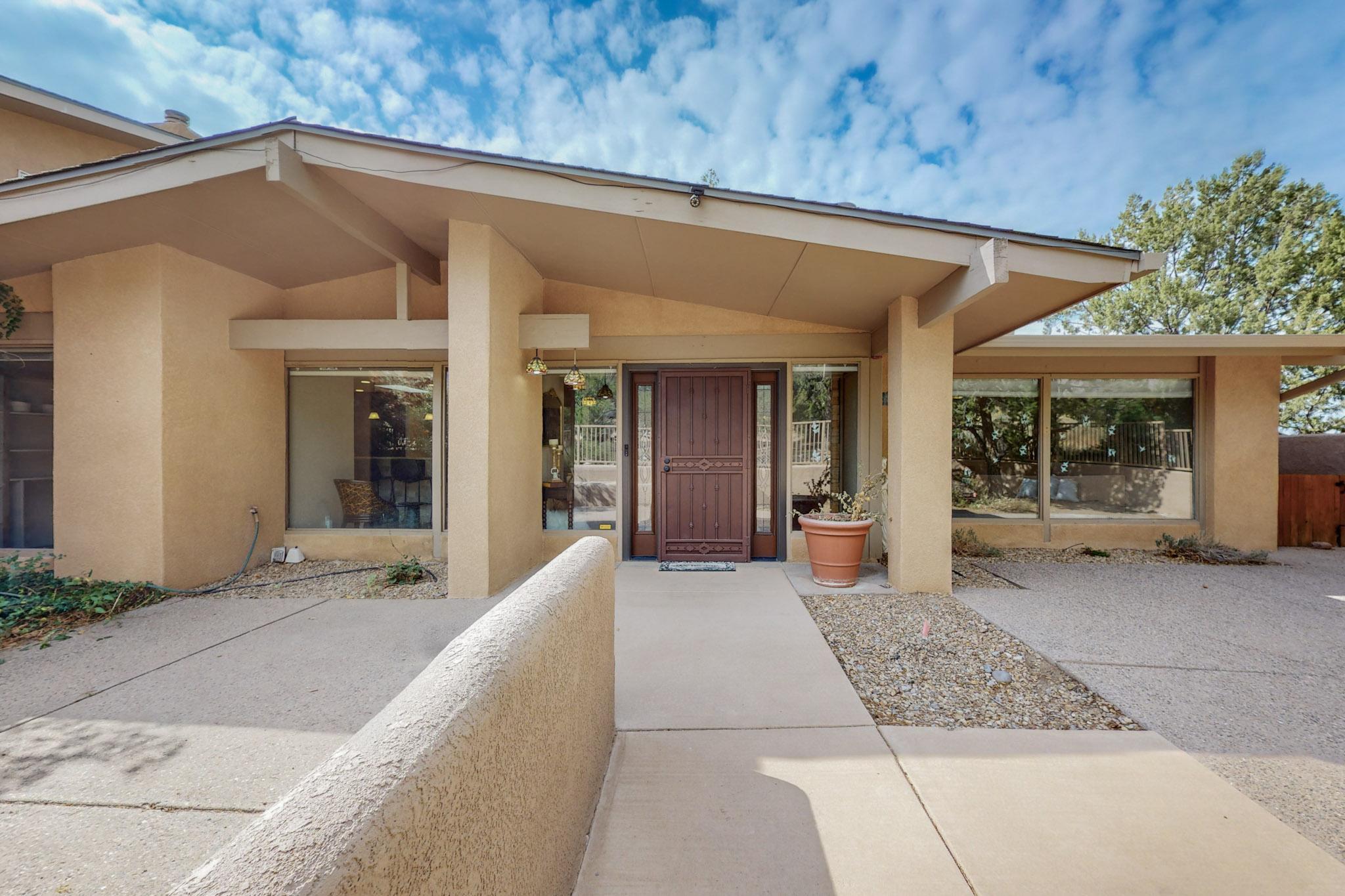 Absolutiely stunning SANDIA HEIGHTS home located on a large  lot.(1.09acre) with STELLAR VIEWS! This exceptional property features 4/5 BR+ a Casita (two Primary Suites 1 up, and 1 down) & 3 other large secondary bdrms. This amazing property includes a huge flex space and office providing addtional versatility and comfort. 3 living areas, formal dining, and absolutely stunning gourmet kitchen with Wolf appliances. Enjoy the breathtaking VIEWS of the Sandias & City Lights from the large enclosed couryard or  fabulous backyard chich boasts multiple patios and kiva FP. This home is the perfect blend of luxury & space, which is surrounded by remarkable scenery, ideal for refined living in coveted SANDIA HEIGHTS! Copious storage throughout. 2 Car Garage Very Nice Home!