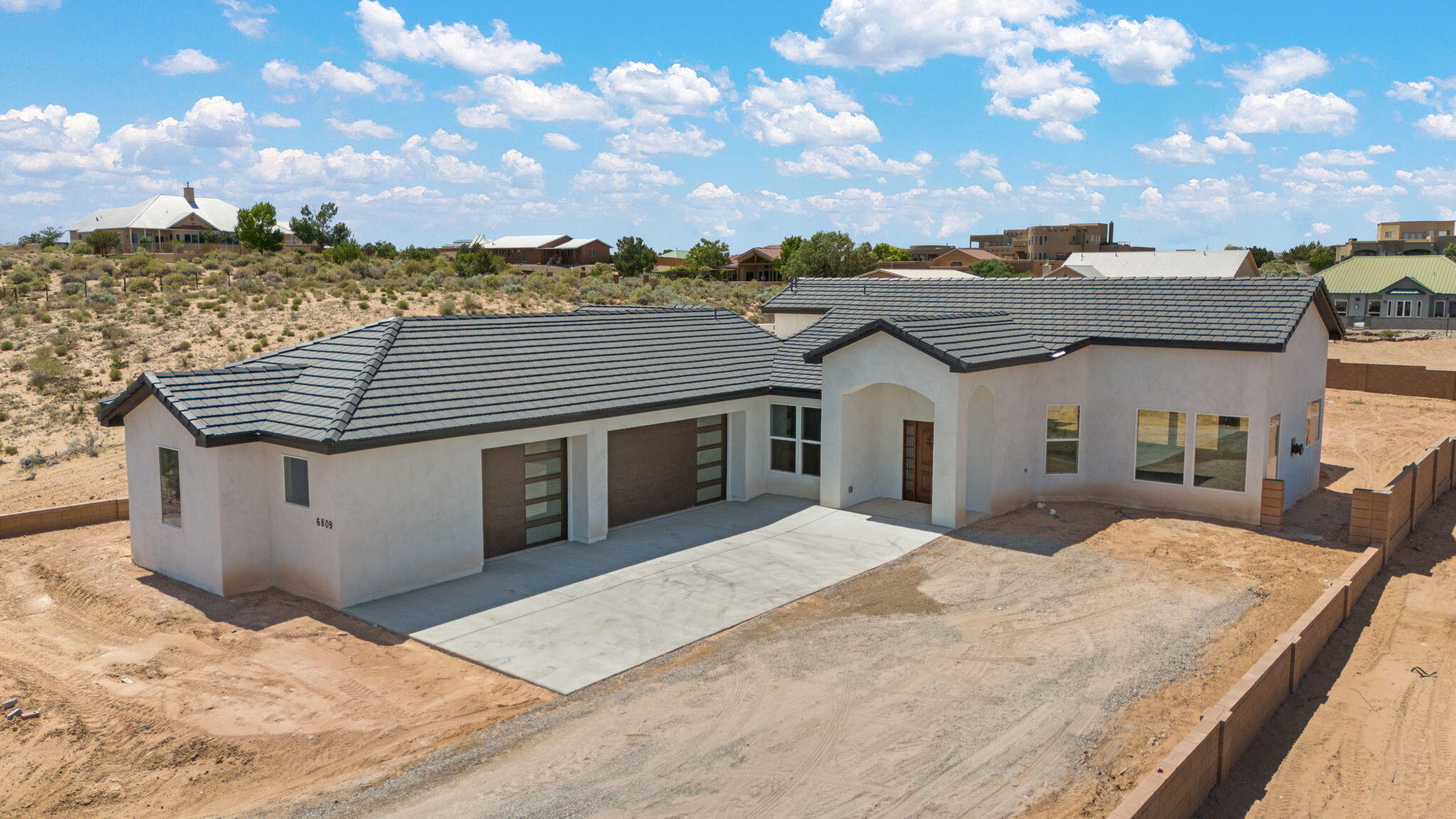 New construction Custom Built home will be ready for buyers late June/early July in Rio Rancho with amazing views! Enter the home through a beautiful front door and take in the open concept floor plan. A large living area with a a custom gas fireplace with blower flows seamlessly into the amazing kitchen. The kitchen with its huge island and large walk-in pantry offers a Frigidaire gas stovetop, microwave, dishwasher,double oven, granite countertops and beautiful oak cabinets. The large primary bedroom with well appointed primary bath will sure to please the new buyers. All other bedrooms also have their own amazing bathrooms. An oversized 1100 sq ft 3-car garage offers extra space for additional needs. There is a large back covered  patio. Pictures depict same home at different location.