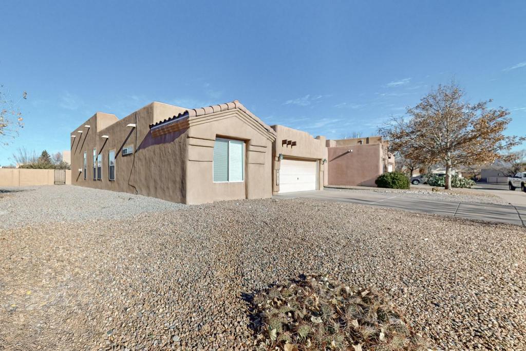 Welcome to 10216 Sand Sage Dr NW, perfectly situated in a prime Albuquerque location near Cottonwood Mall, Costco, Walmart, and top-rated schools. Enjoy quick access to shopping, dining, parks, and walking trails, blending suburban tranquility with urban convenience.This three-bedroom, two-bathroom home sits on a spacious corner lot with owned solar, quartz countertops, new appliances, a fireplace, and a two-car garage. Perfect outdoor space and privacy.