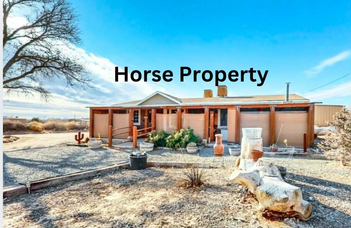 Don't miss this amazing opportunity to own your own horse property in beautiful Corrales. Sitting on almost an acre of land with incredible mountain views, this manufactured home won't last long. Outside you'll love all the pipe fencing, the 7 covered horse stalls, tackroom and arena. An additional covered canopy and storage area allows for protection of your equipment/hay. Enter the comfortable home through a full length covered patio with its own wood burning stove. You'll love the laminate flooring and 2 living areas which will allow you to spread out. Stay warm in the winter with the newer furnace and cool during the summer with recently added refrigerated air conditioning.