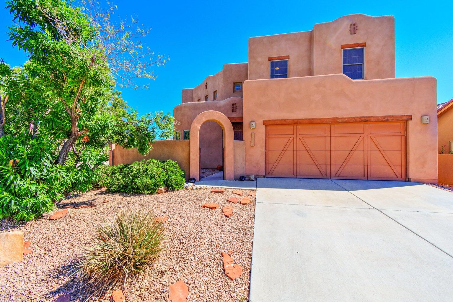 Nestled on a corner lot in the desirable Orchards 2 community, this exquisite Pueblo-style home by Tiffany Homes offers thoughtfully designed living space. This home provides ample room for both relaxation and entertaining. A gated courtyard entry welcomes you into the home, where you'll be greeted by a stunning living area with soaring ceilings, custom wood vigas, and a charming Kiva fireplace.The spacious kitchen is a highlight, showcasing upgraded oak cabinetry, sleek granite countertops, stainless steel appliances, a large central prep island, and a pantry for added convenience. There is small park located down the street, walking trail to the bosque, shopping centers near by and easy access to I-25. This home combines comfort, style, and convenience. Don't miss out on this one!