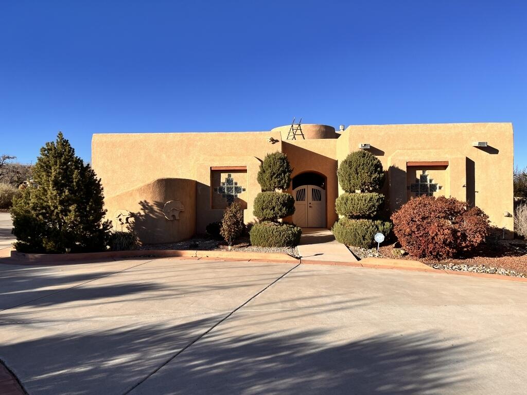 This gorgeous Corrales home located in the much sought-after Sky View Acres.  This Pueblo-style custom home is on a large corner lot with a striking view of the Sandia Mountains. Inside the home find an open plan complete with vigas  latillas, tile and hand-carved columns that display that New Mexico charm.  Custom-built, this home has windows with mountain view along the entire east side.