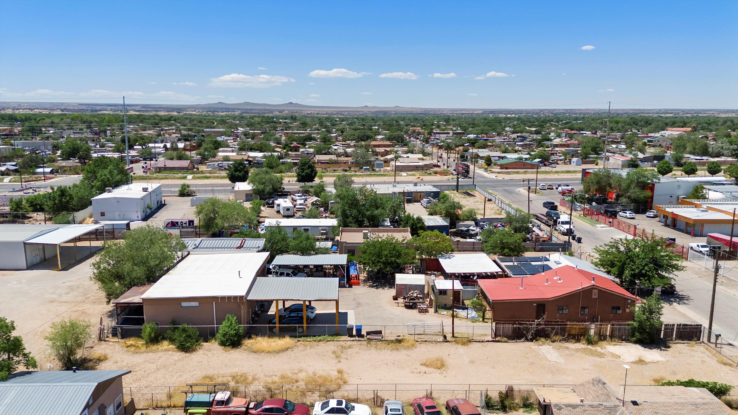 Prime Commercial Property with Two Homes, Office Space, and Workshop - Ideal for Investors or Business Owners Welcome to 120-122 Aztec Road NW in Albuquerque, NM 87107, a unique commercial property zoned M1 offering a wide range of possibilities. This expansive property sits on a spacious lot and includes two residential homes, a sizable office, and a 30 x 32 workshop/garage, providing ample space for a variety of commercial and residential uses. As you enter the property, you'll appreciate the convenient backyard access on both the east and west sides. The commercial garage is fully insulated, equipped with commercial-grade electricity, and includes a loft for additional storage.